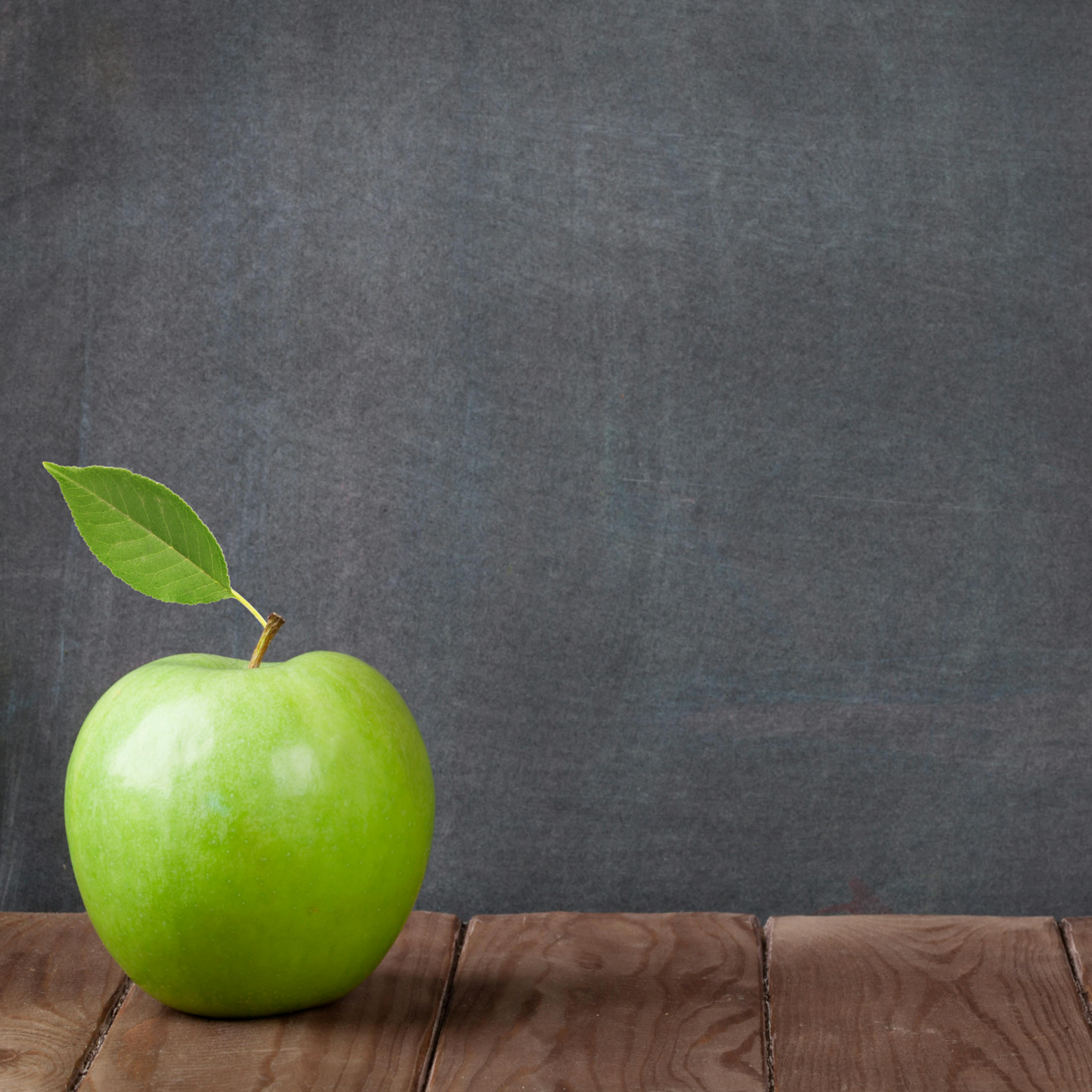 Green Apple in front of blackboard - back to school emotions