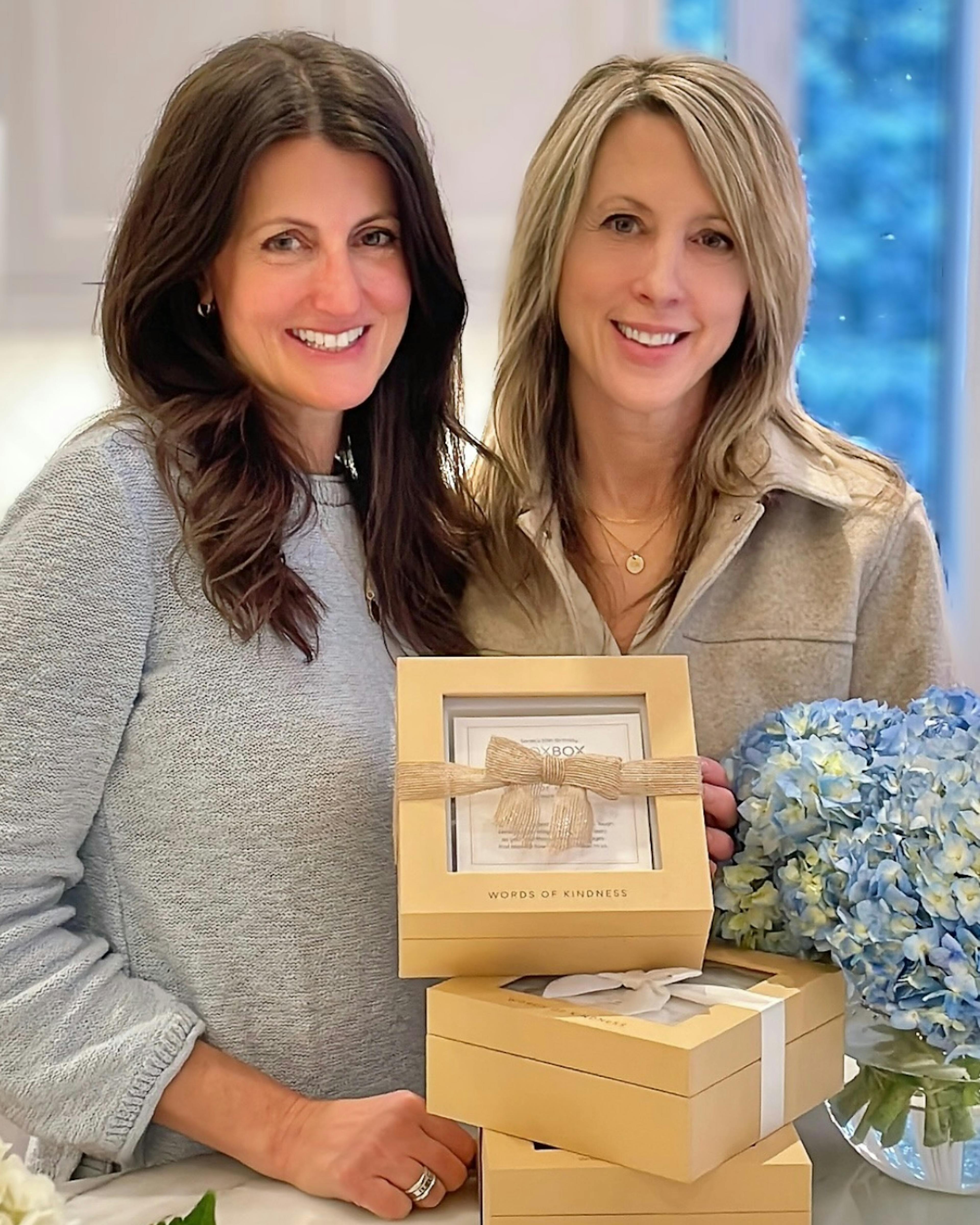 Co-founders of Woxbox, Carey & Cindy, holding a Woxbox keepsake gift