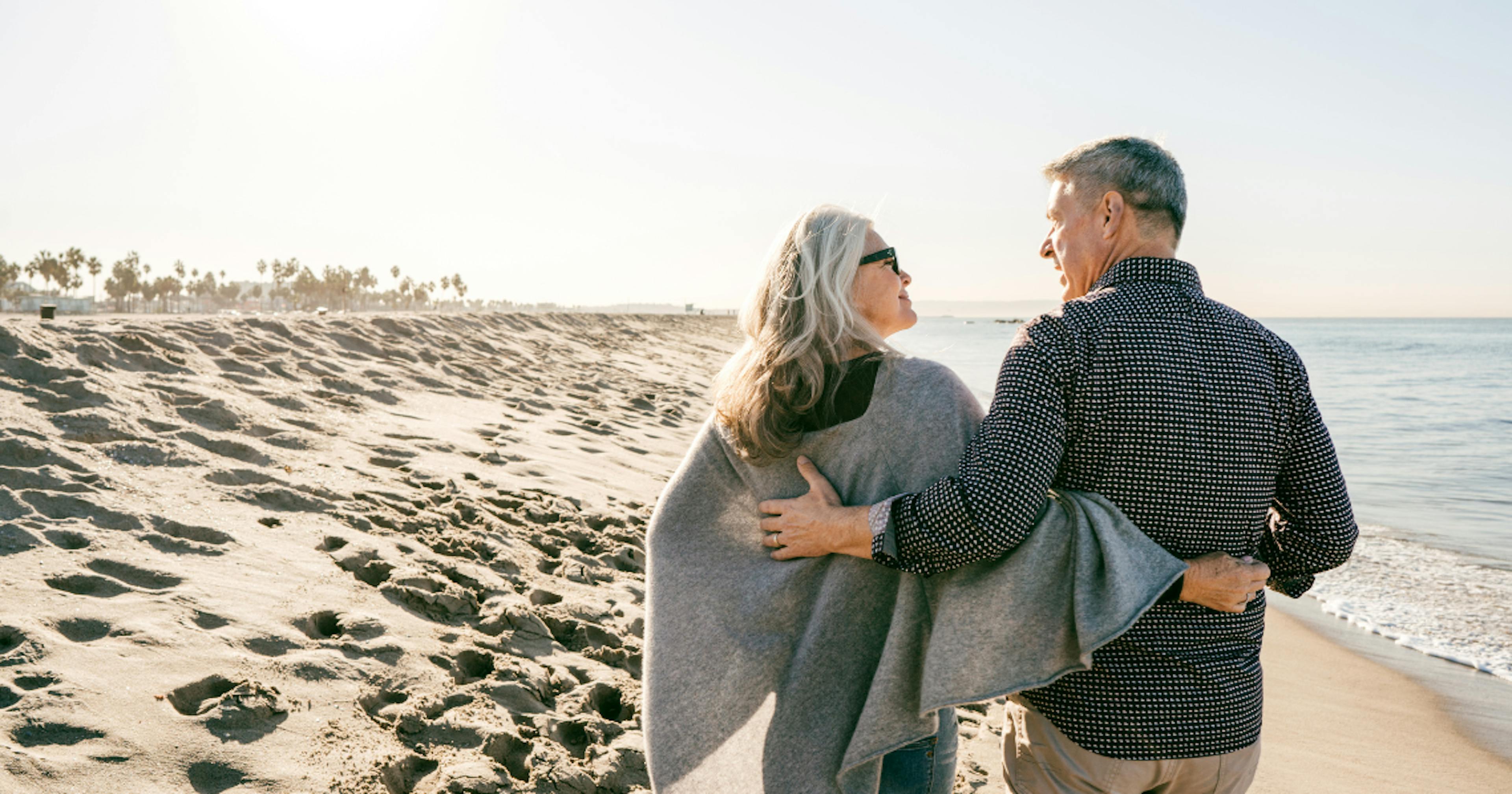 Retired couple walking on the beach
