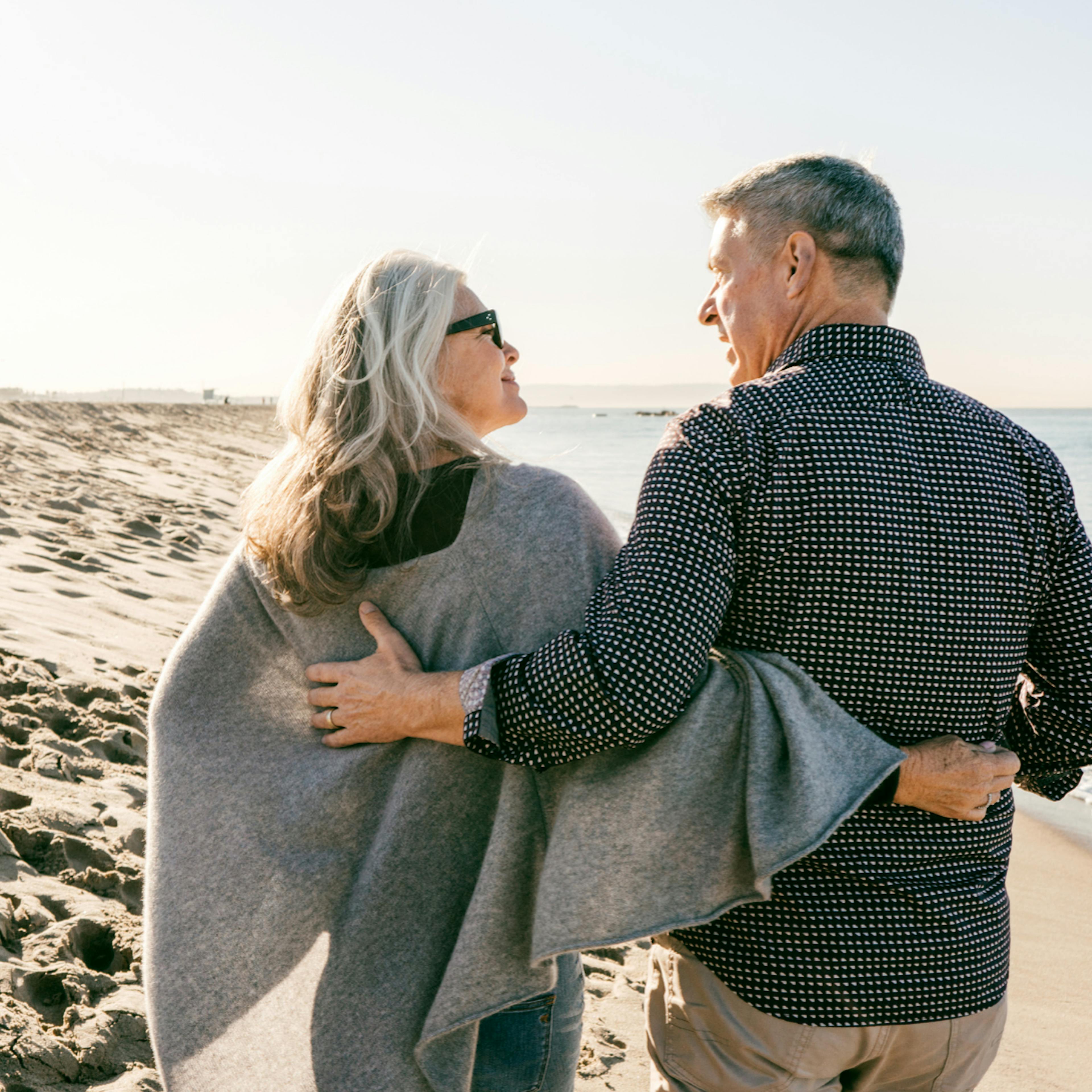 Retired couple walking on the beach