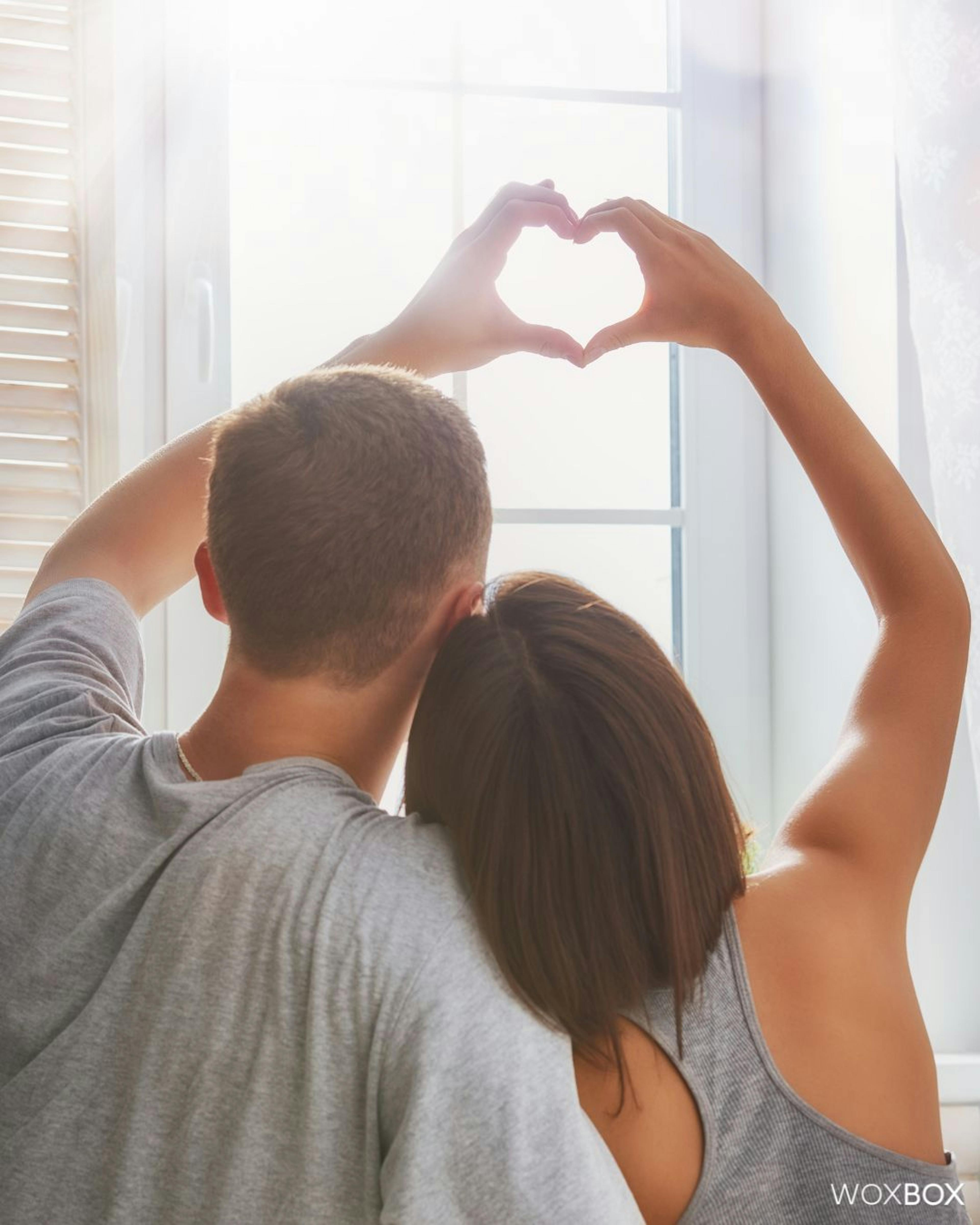 Couple making a heart with their hands to show how much they love each other