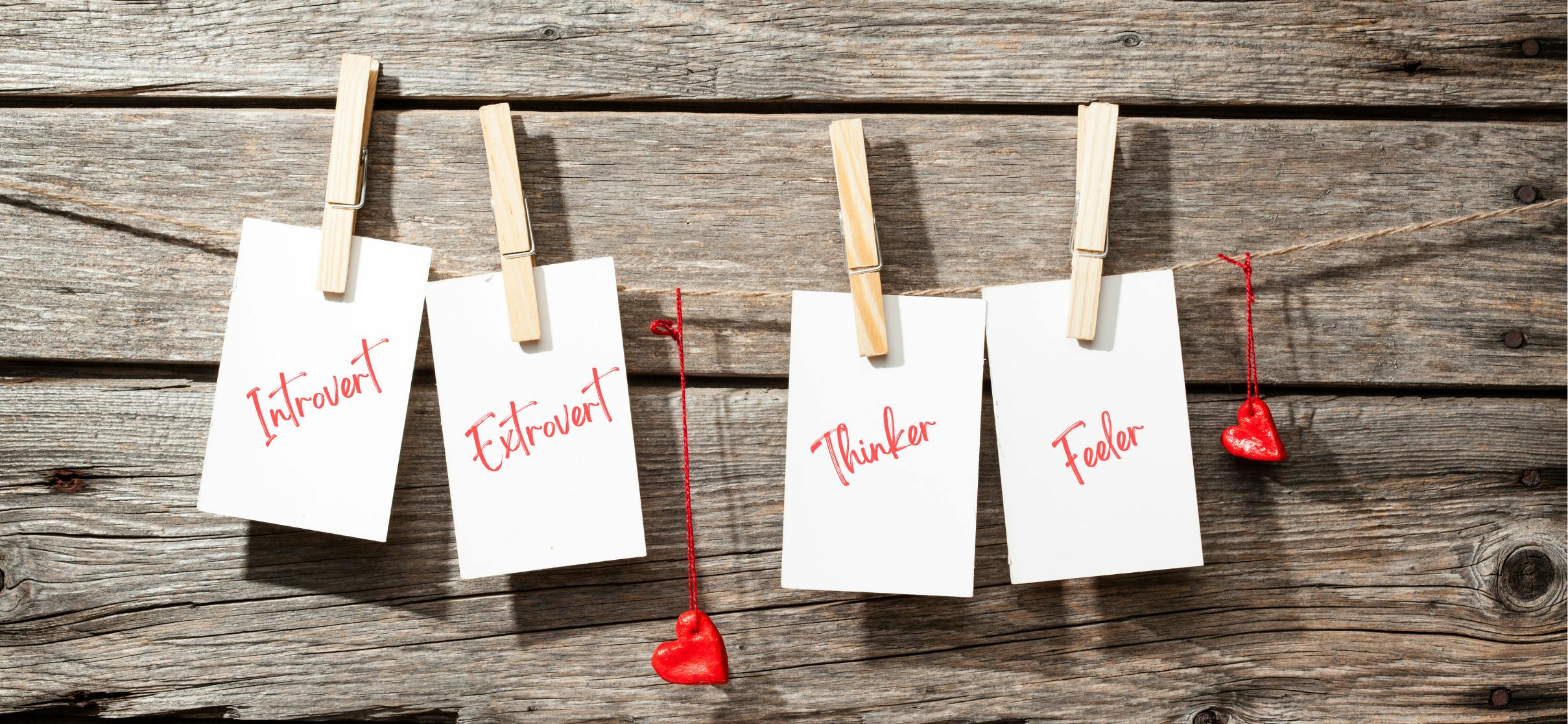 Four personality types written on pieces of paper: Introvert, Extrovert, Thinker, Feeler