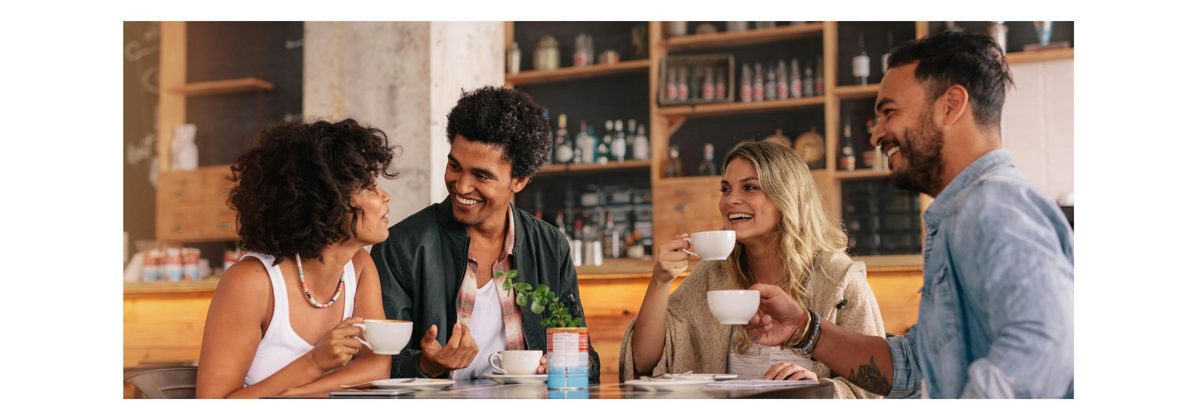 Four friends with different personality types discussing a Woxbox while having coffee