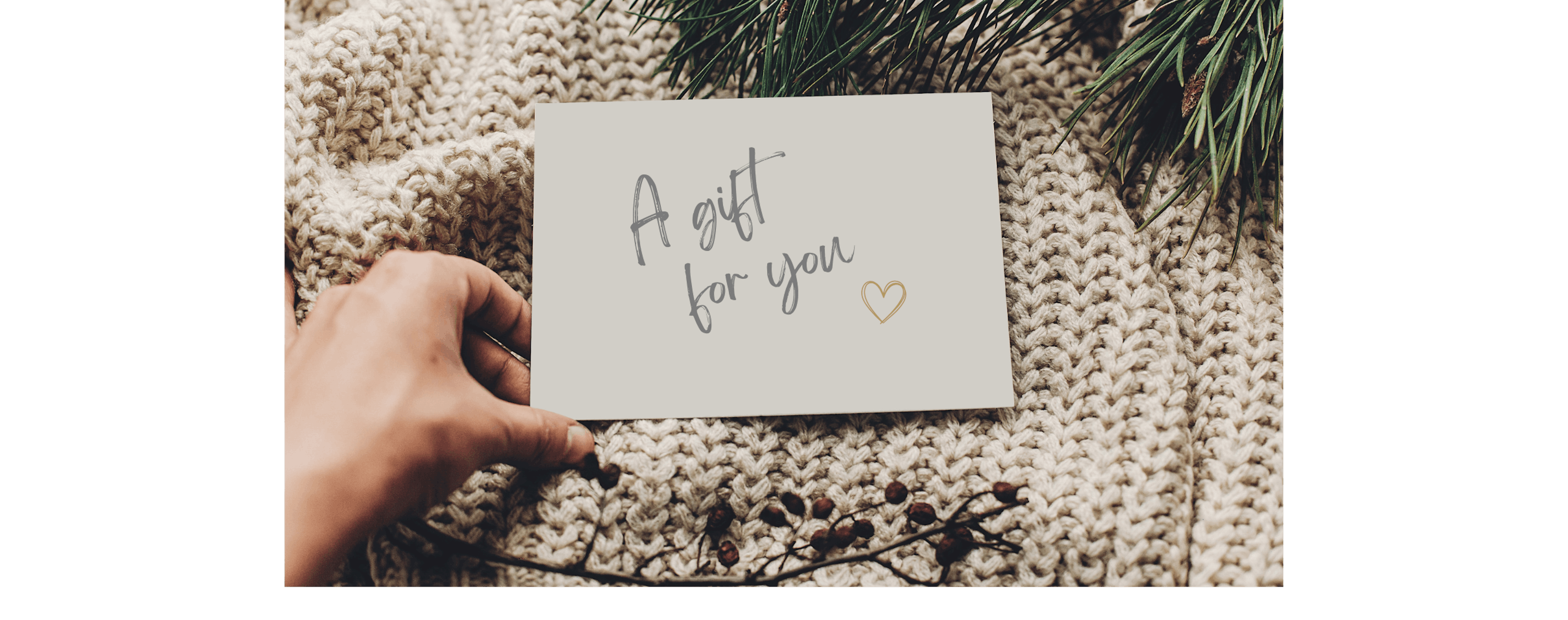 Person giving a gift to the person who has everything, with a handwritten card that says "A gift for you"