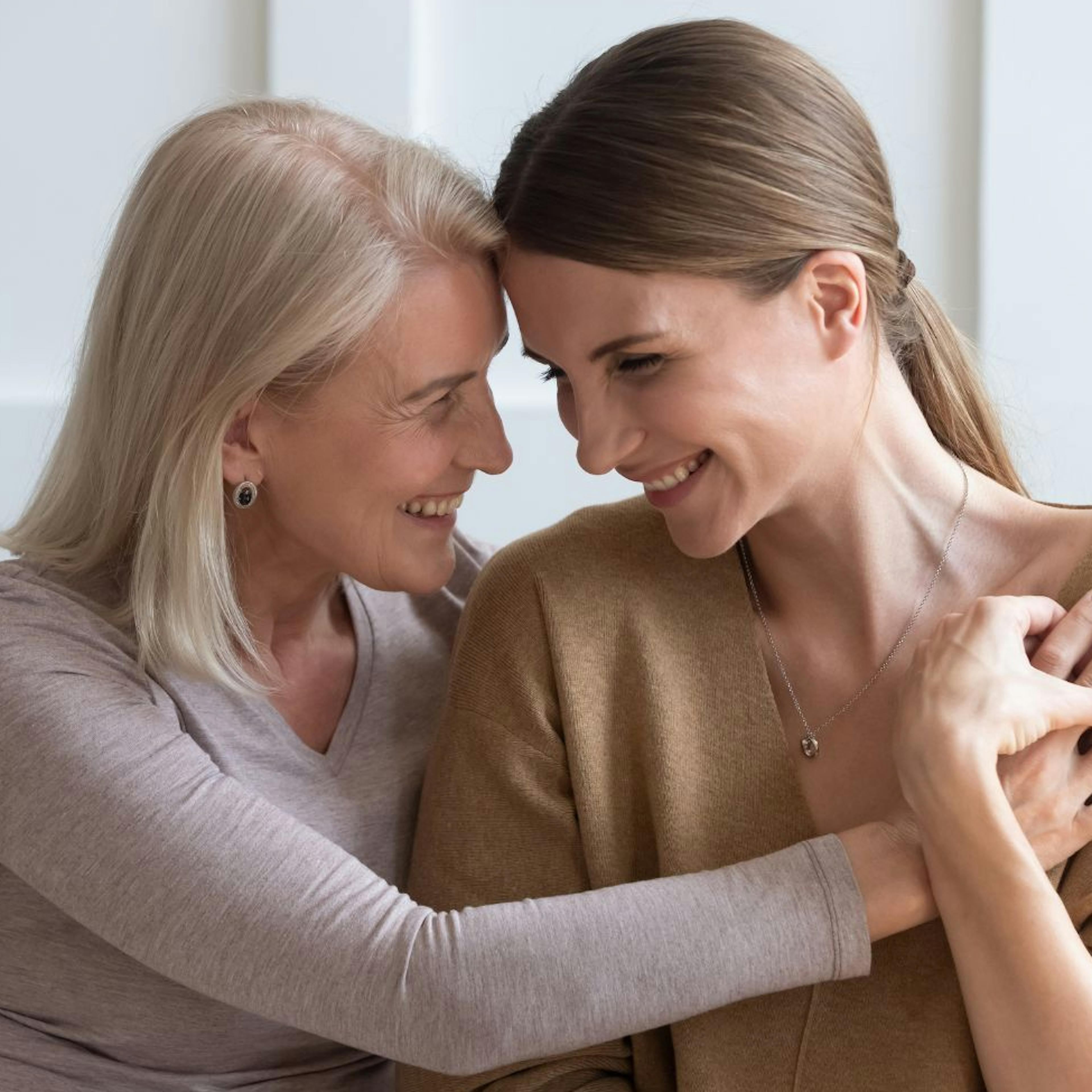 Mother giving a hug and bonding with her adult daughter