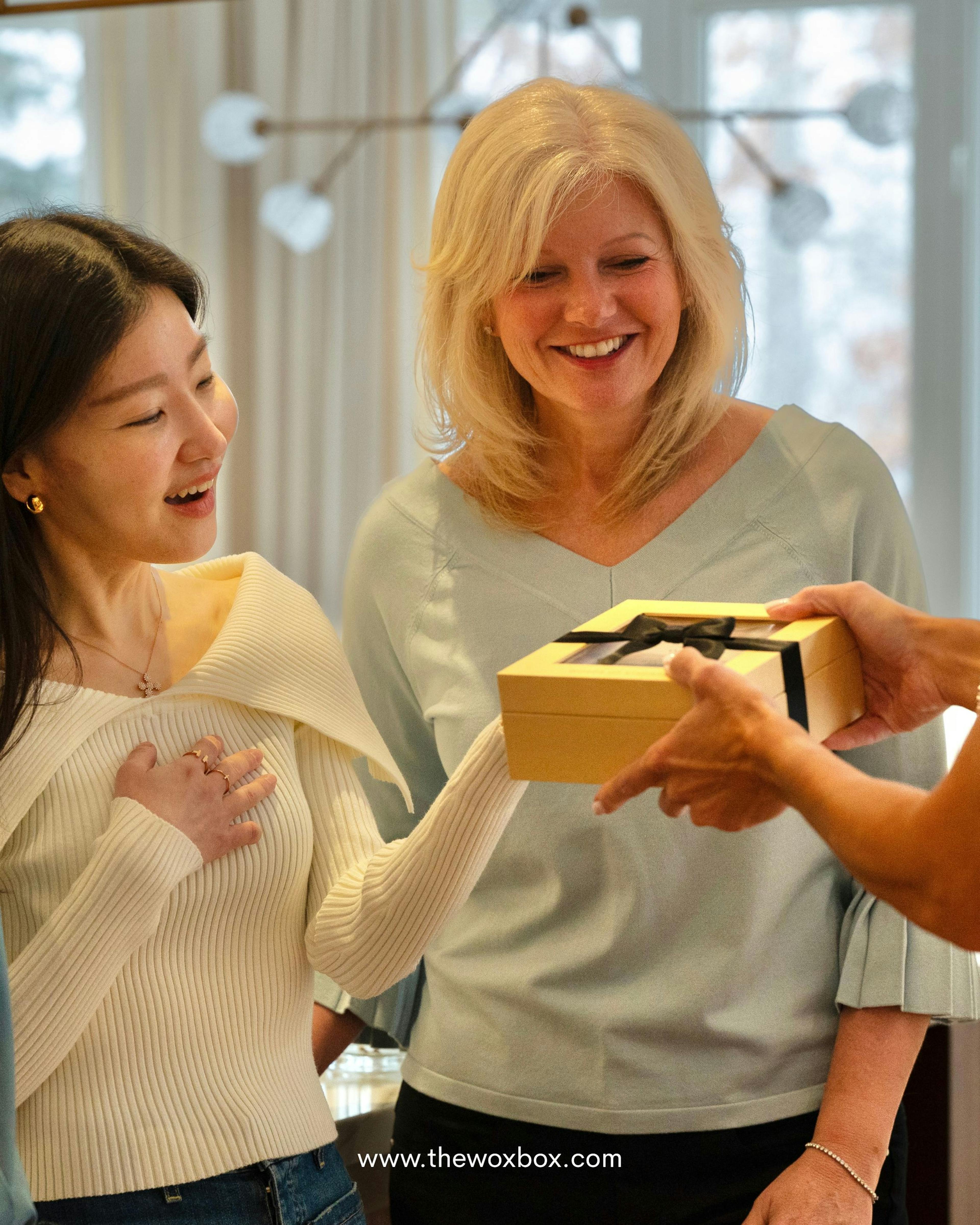 Woman expressing gratitude while she receives a Woxbox gift filled with heartfelt messages from friends and family