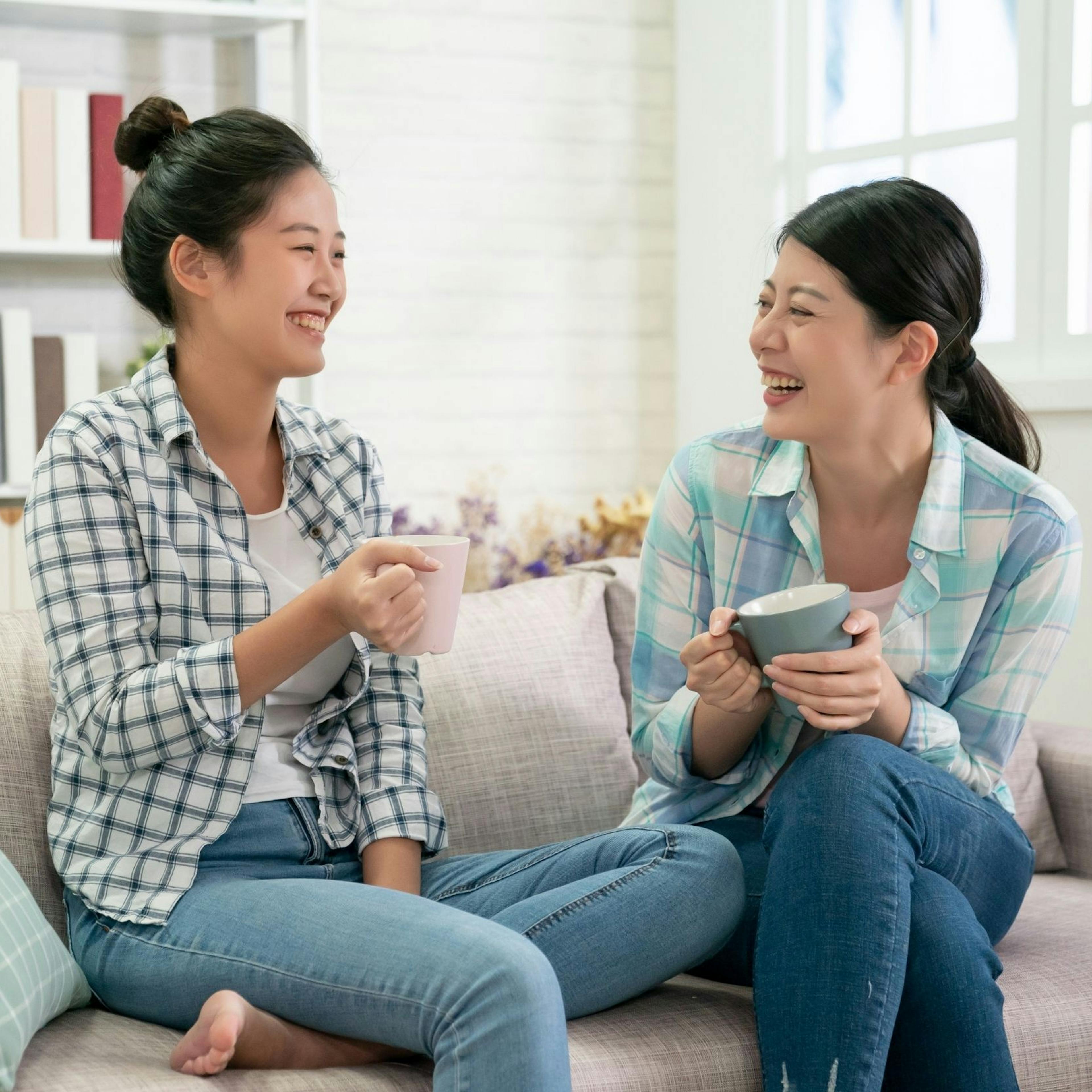 Two friends having meaningful conversation over coffee, demonstrating active listening and connection