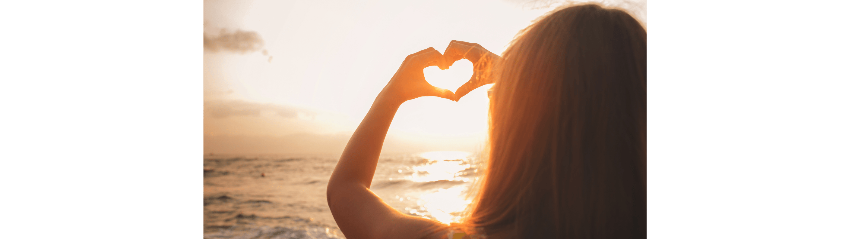 Woman making a heart with her hands, representing the ripple effect of kindness to others