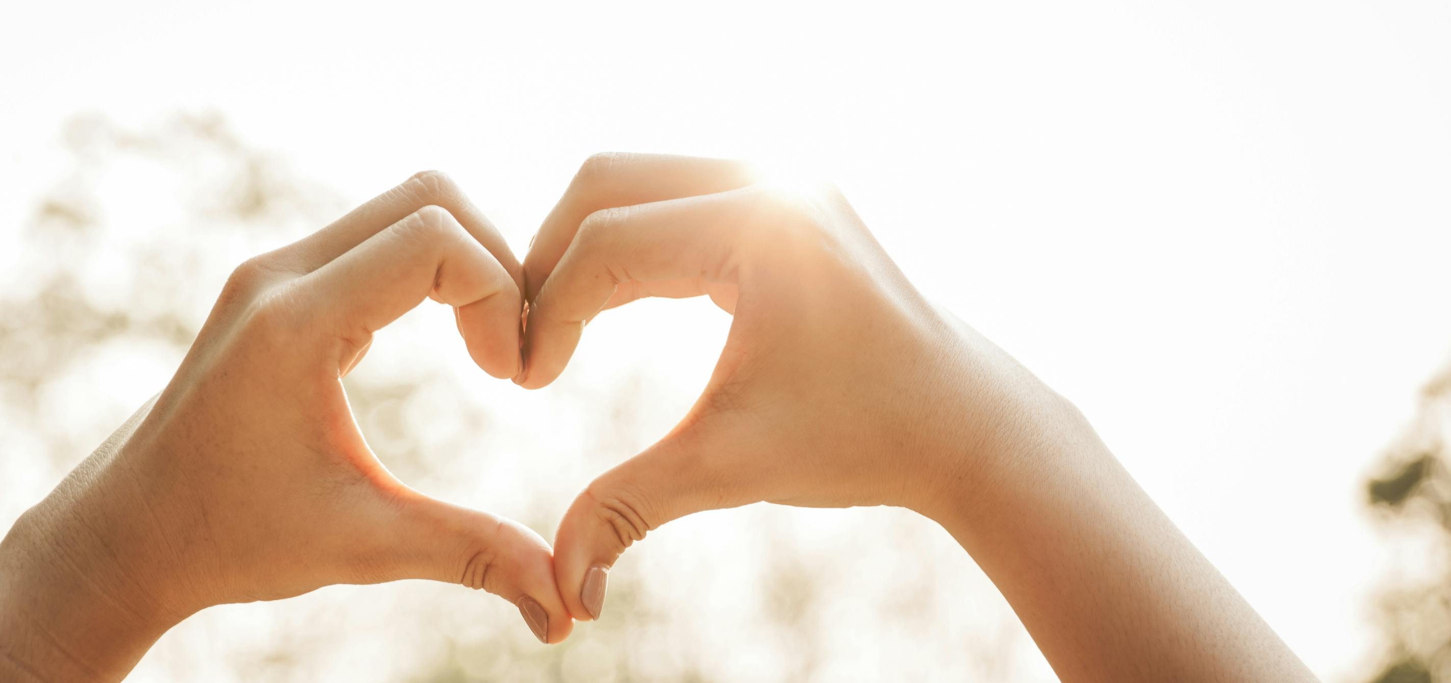 Hands forming a heart, representing meaningful family connections and gratitude
