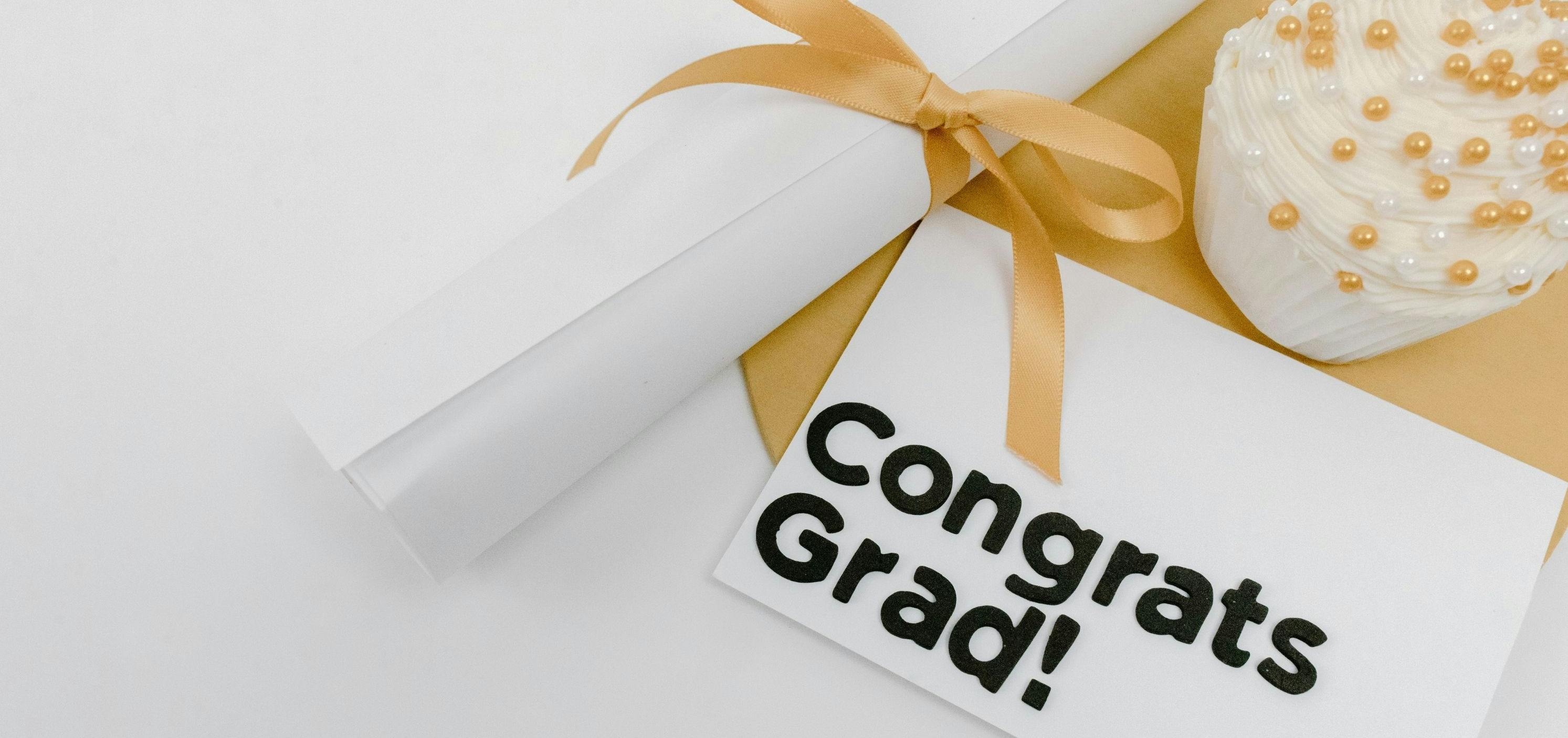 Personalized graduation keepsakes including framed diploma, custom jewelry with graduation year, and handwritten notes of encouragement