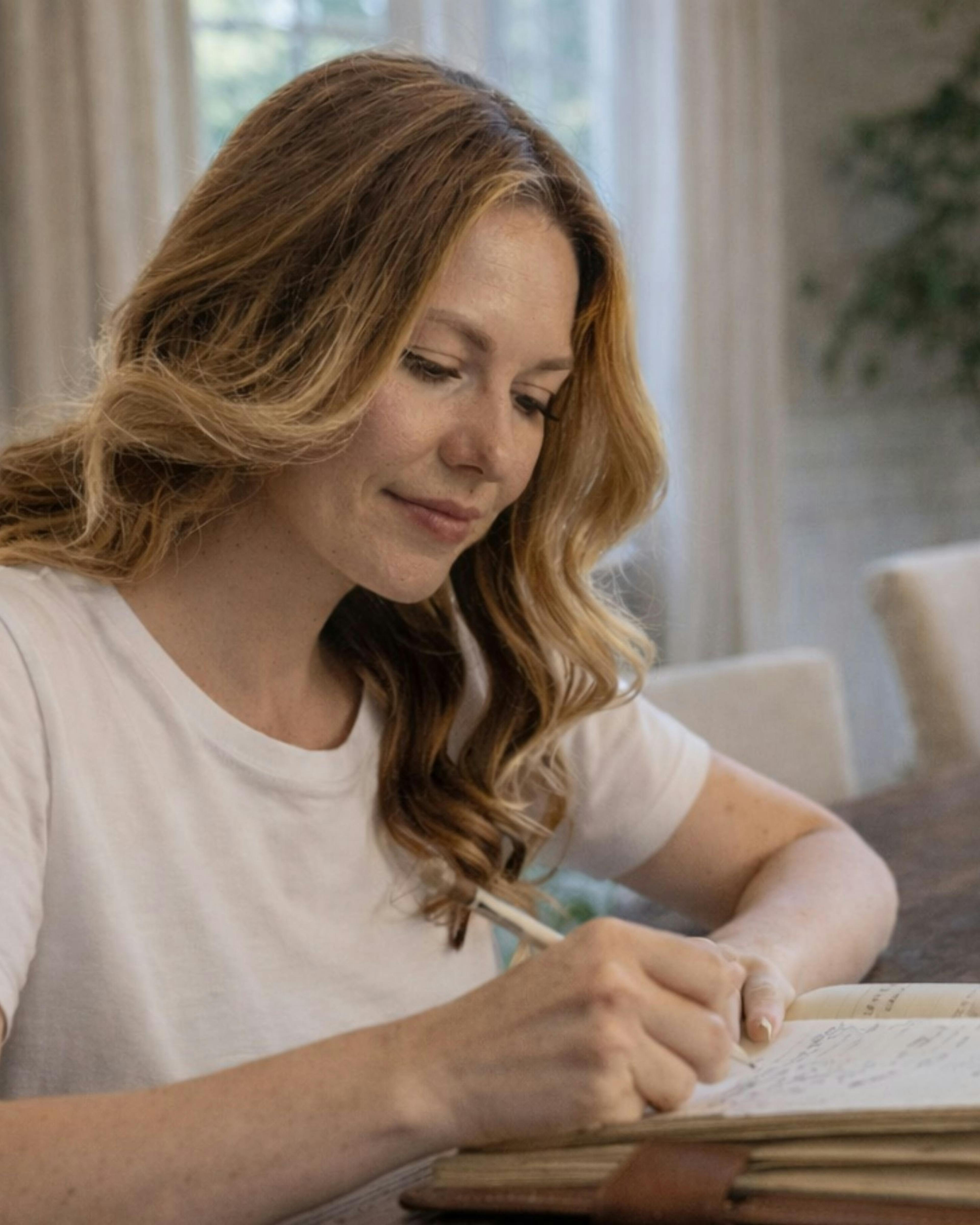 Woman writing in her journal about