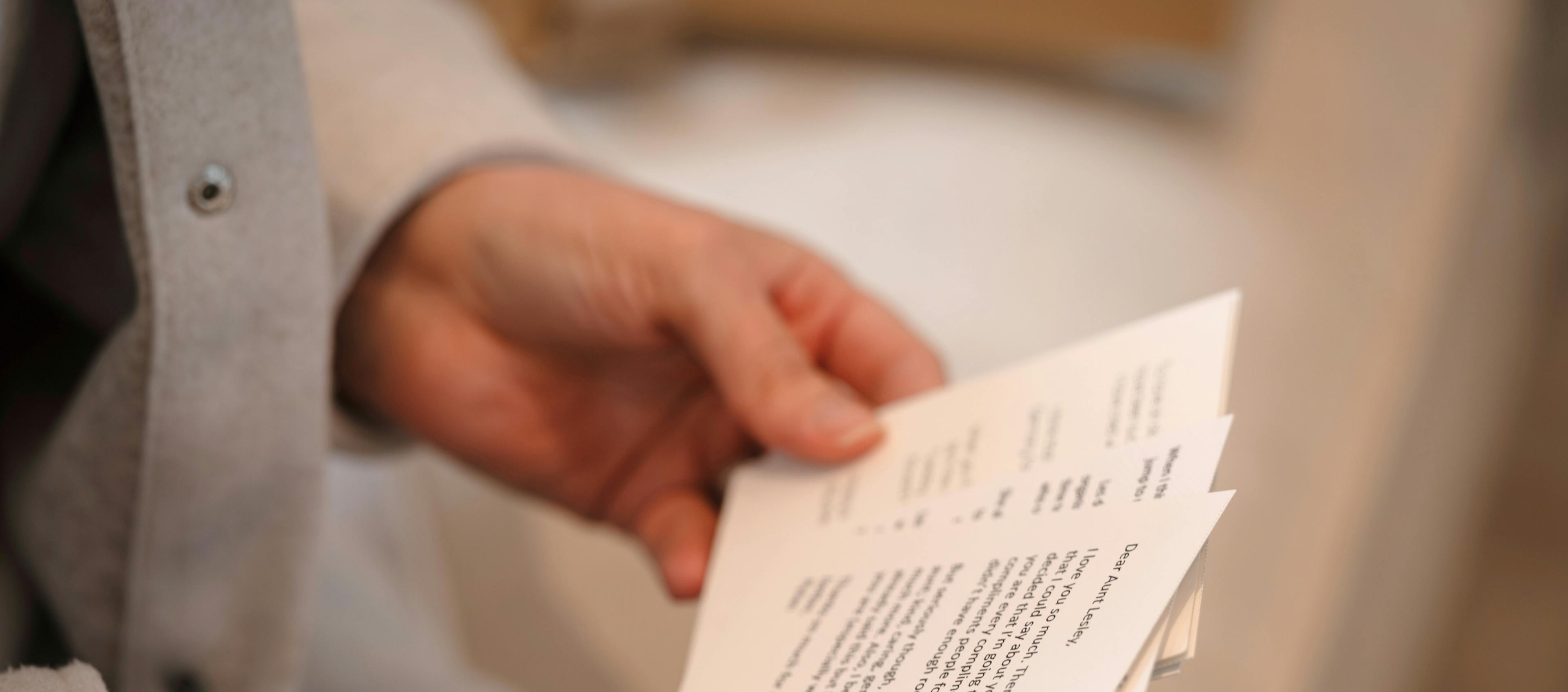 Hands holding sympathy card with personal messages