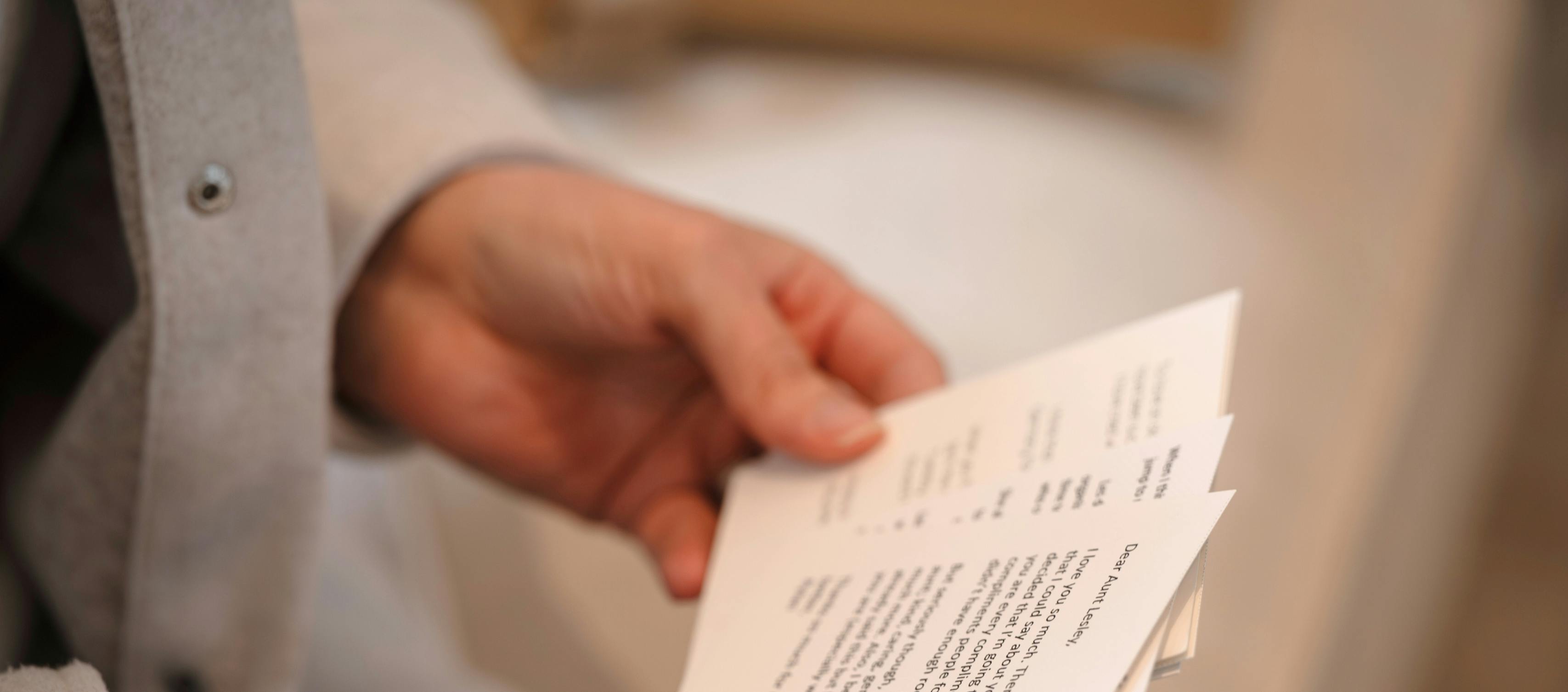 Hands holding sympathy card with personal messages