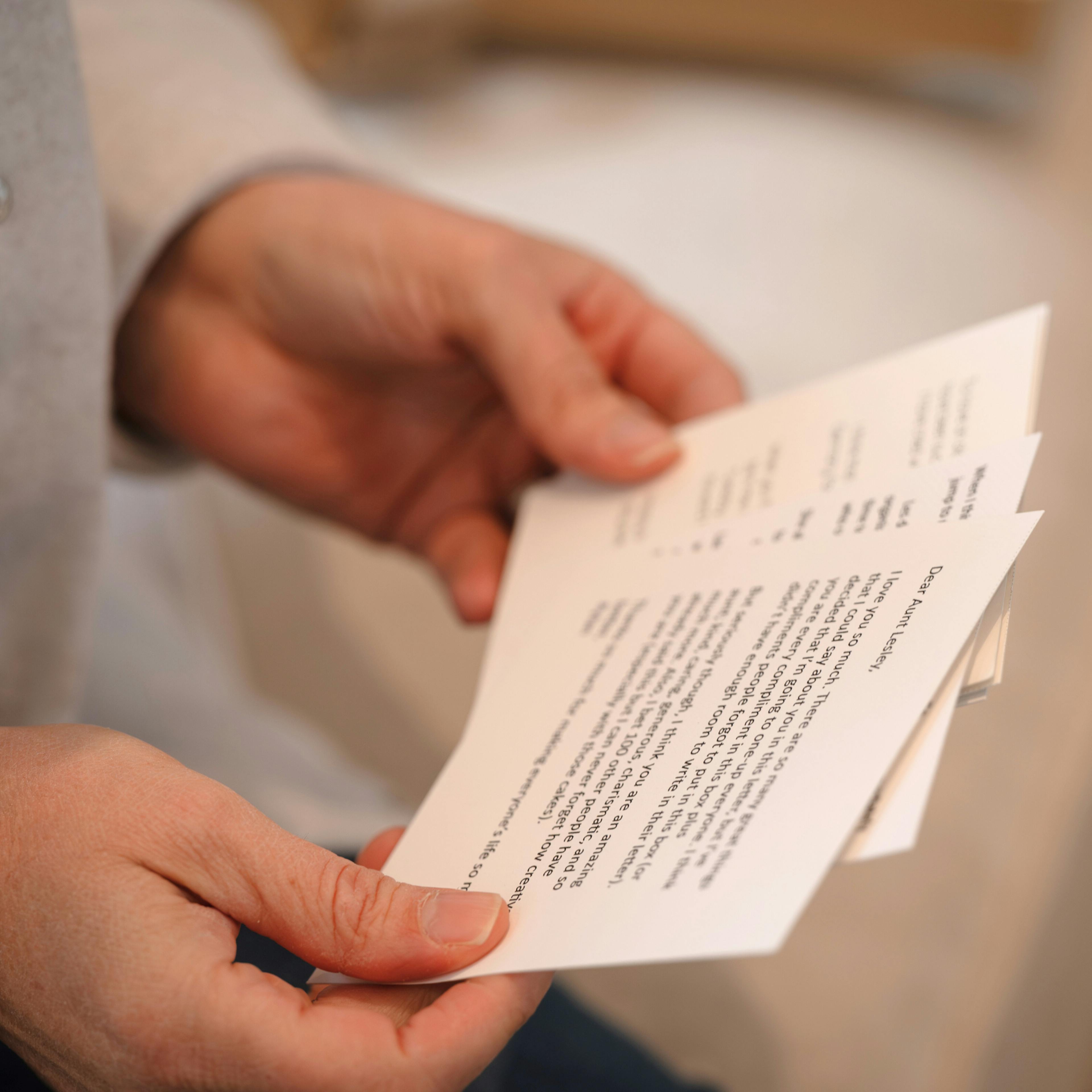 Hands holding sympathy card with personal messages