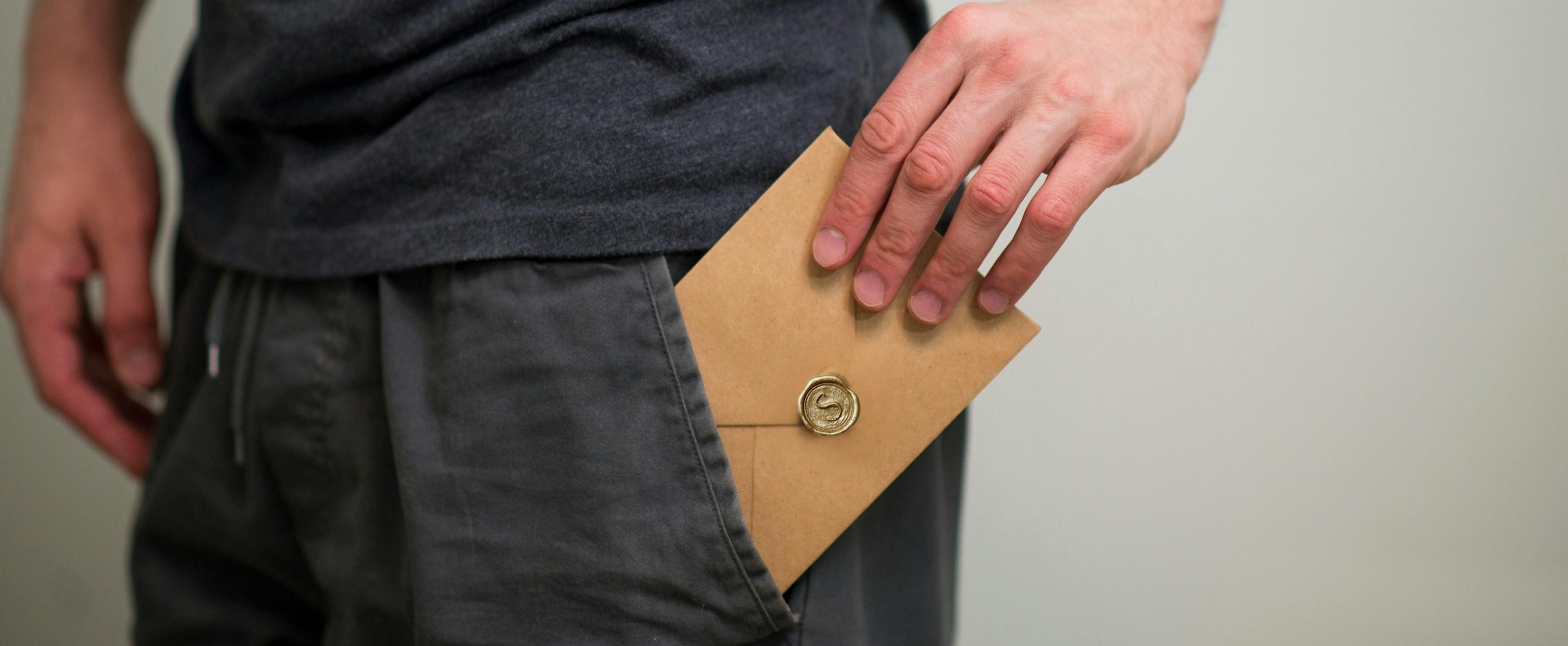 Man putting personal message in his pocket, representing a heartfelt written message he will save