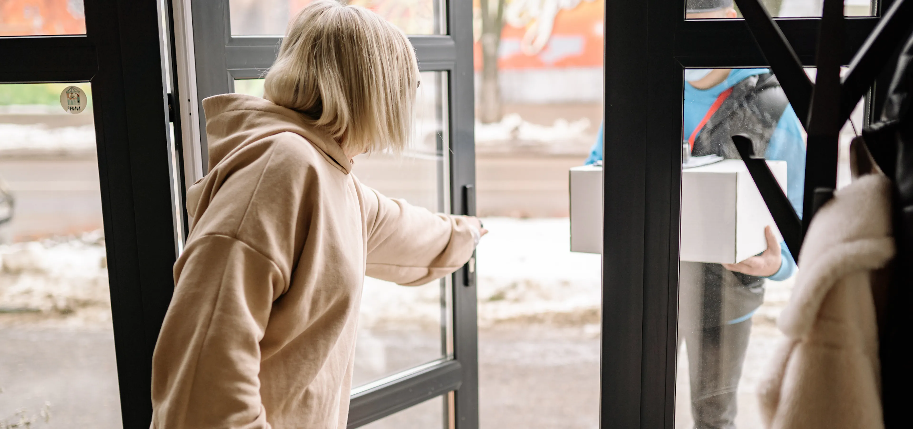 The kind act of opening a door for a stranger, representing how one act of kindness can start a ripple of kindness that spreads to others