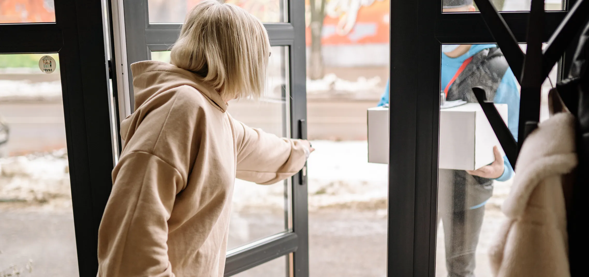 The kind act of opening a door for a stranger, representing how one act of kindness can start a ripple of kindness that spreads to others