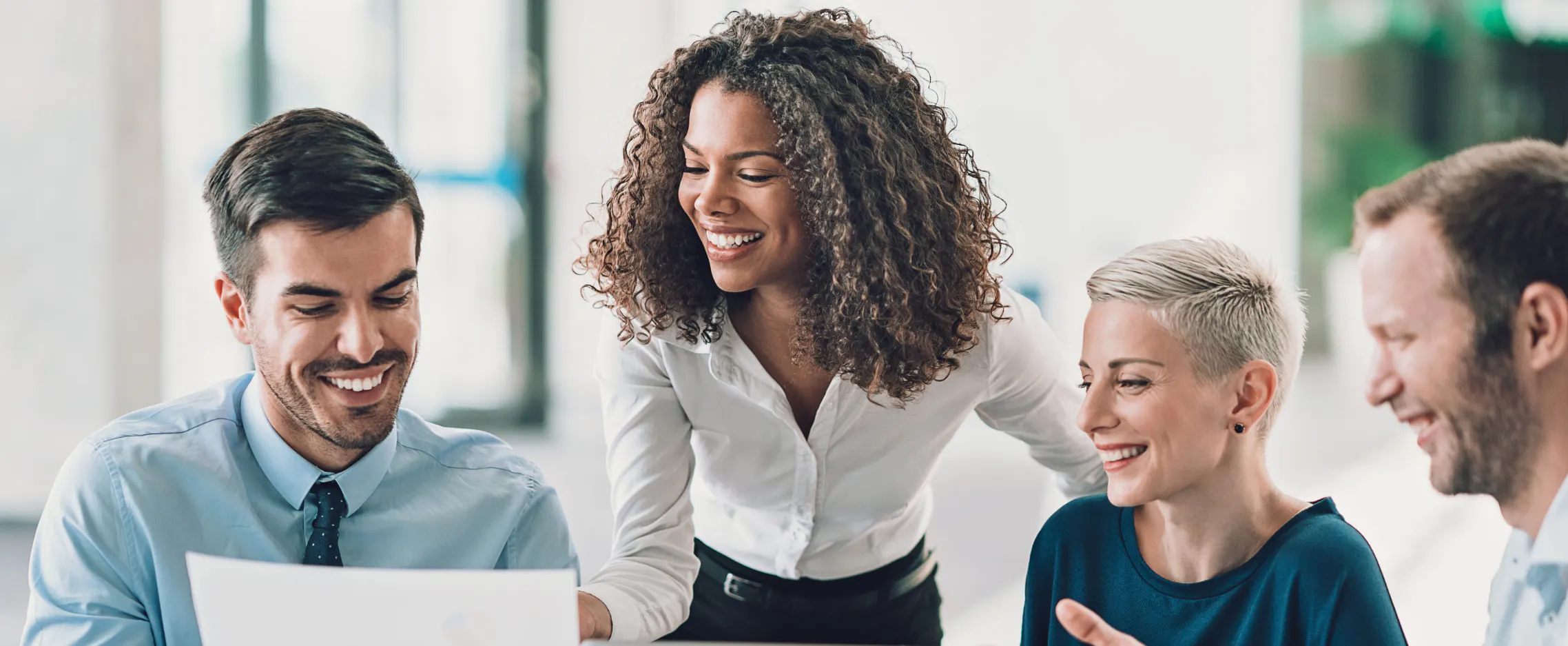 Diverse team of colleagues working together with executive assistant organizing appreciation event in workplace