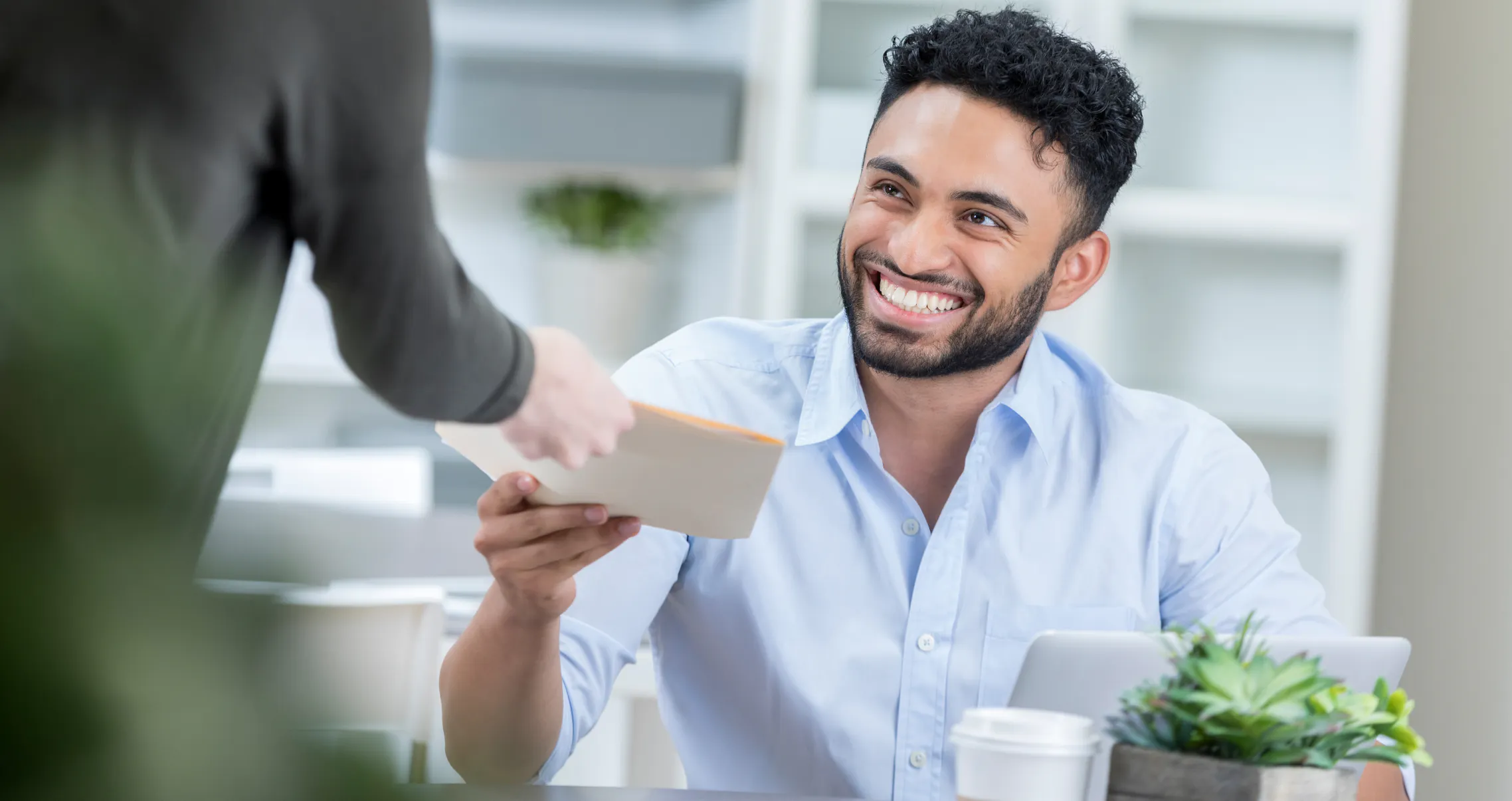 Executive assistant coordinating workplace appreciation and kindness with colleague smiling in modern office