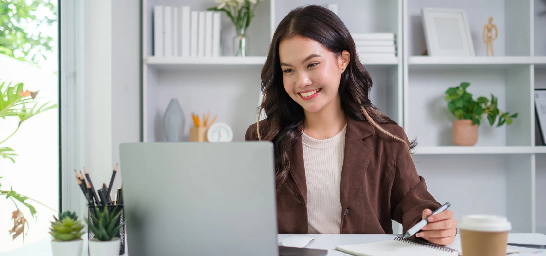 Executive assistant planning workplace appreciation and kindness while smiling in modern office
