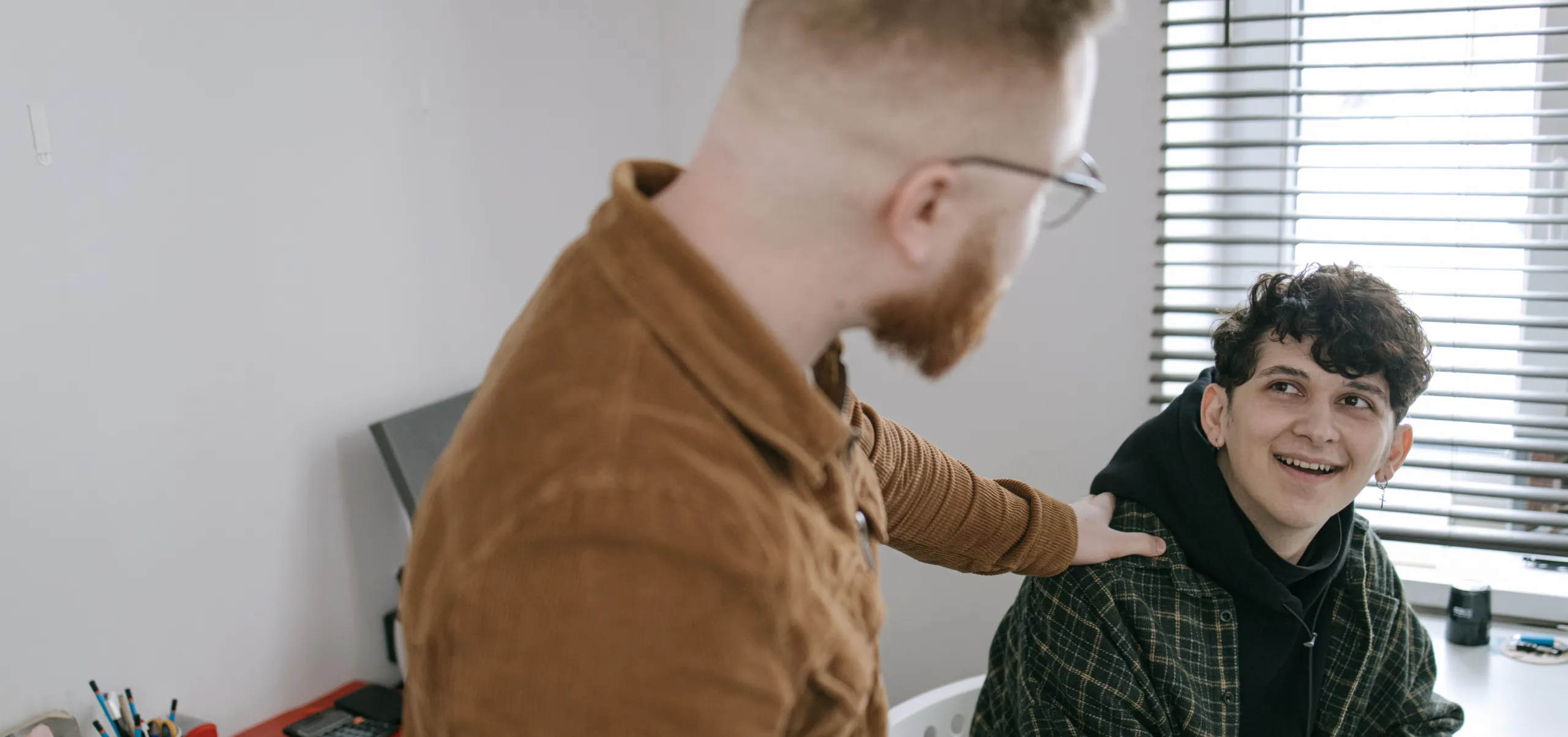 Son smiling as he receives a genuine compliment from his father