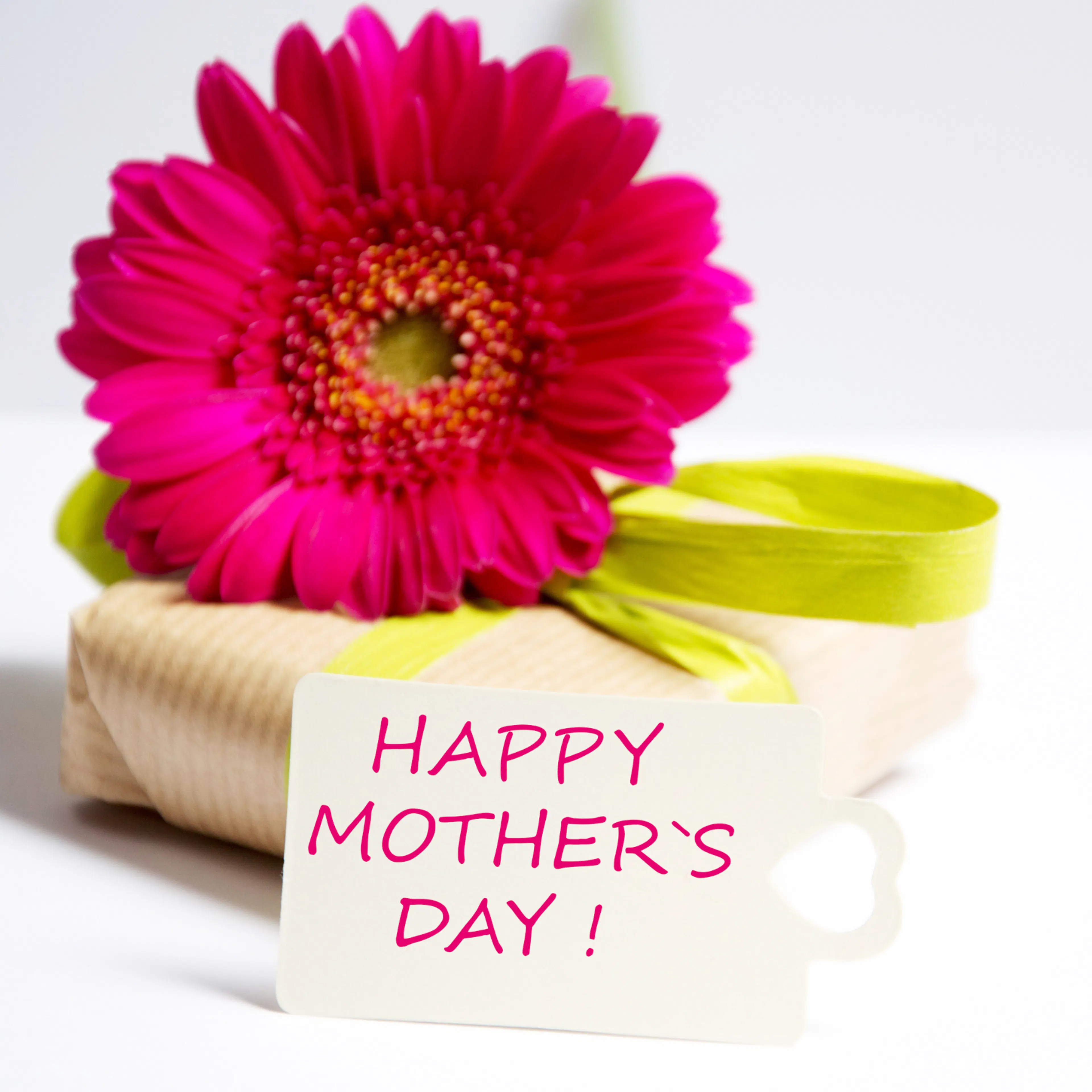 Thoughtful first Mother's Day gift wrapped in a box with a flower on top and Happy Mother's Day card