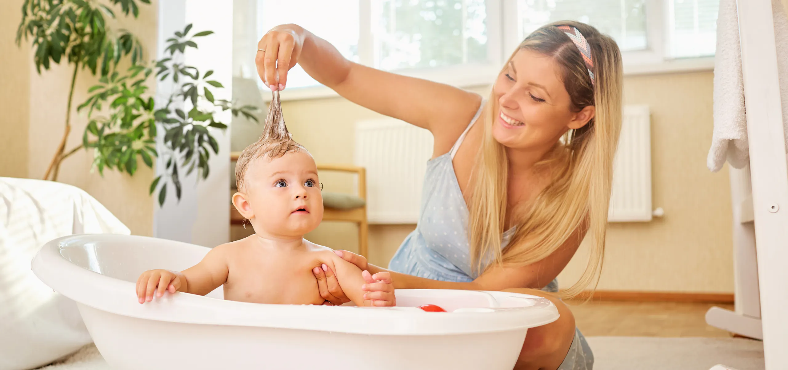 First Mother's Day gift ideas for new moms - mom bathing her baby