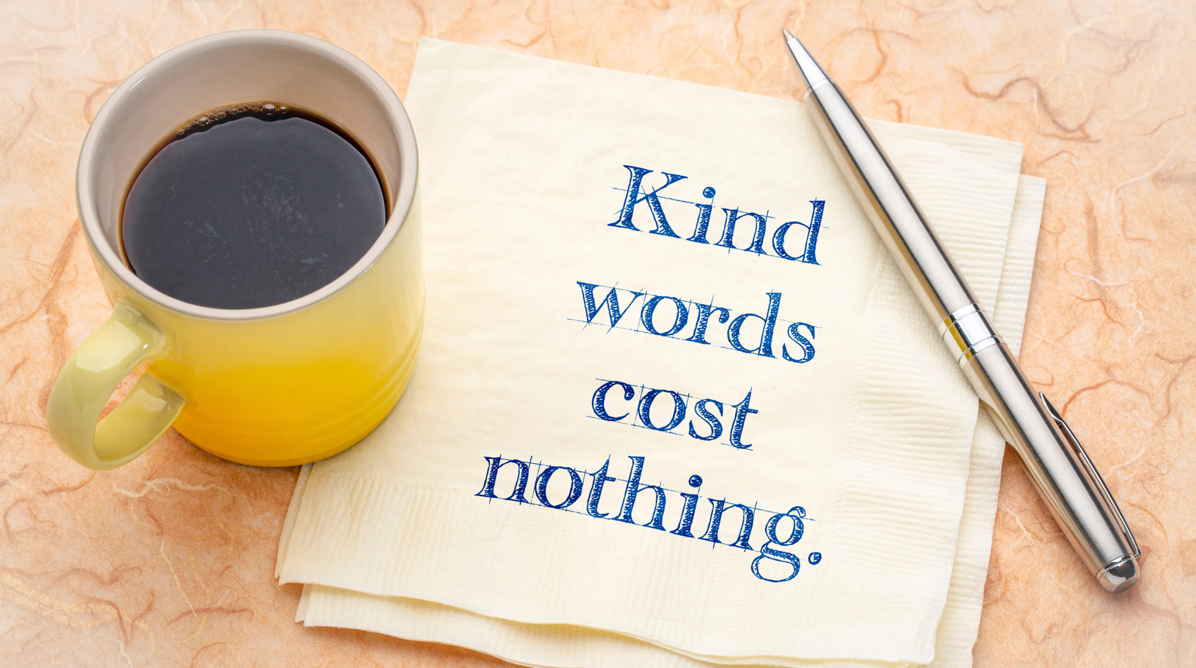 Quote written on napkin, "Kind words cost nothing.", representing how easy it is to be kind