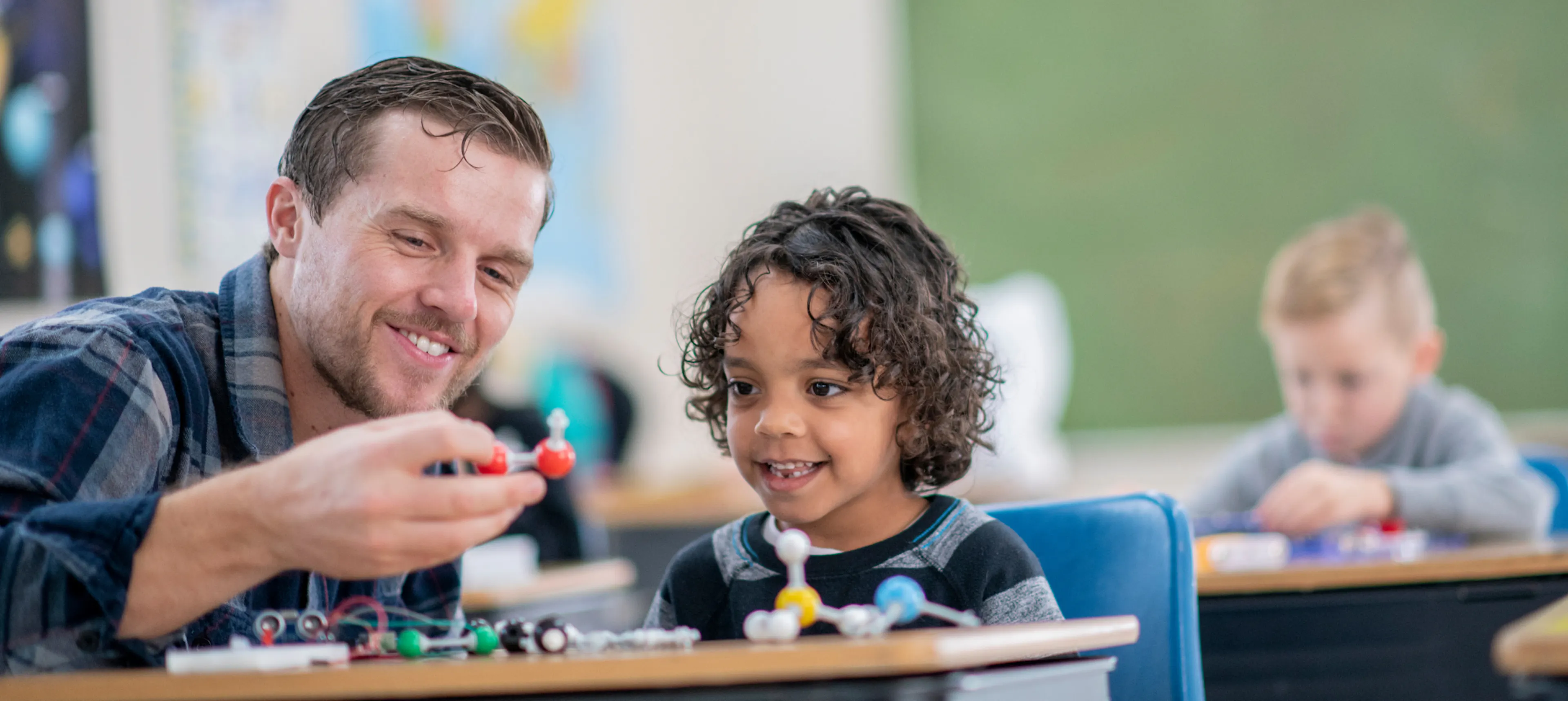 Teacher with smiling student, representing a beloved teacher that the class would buy a group gift for