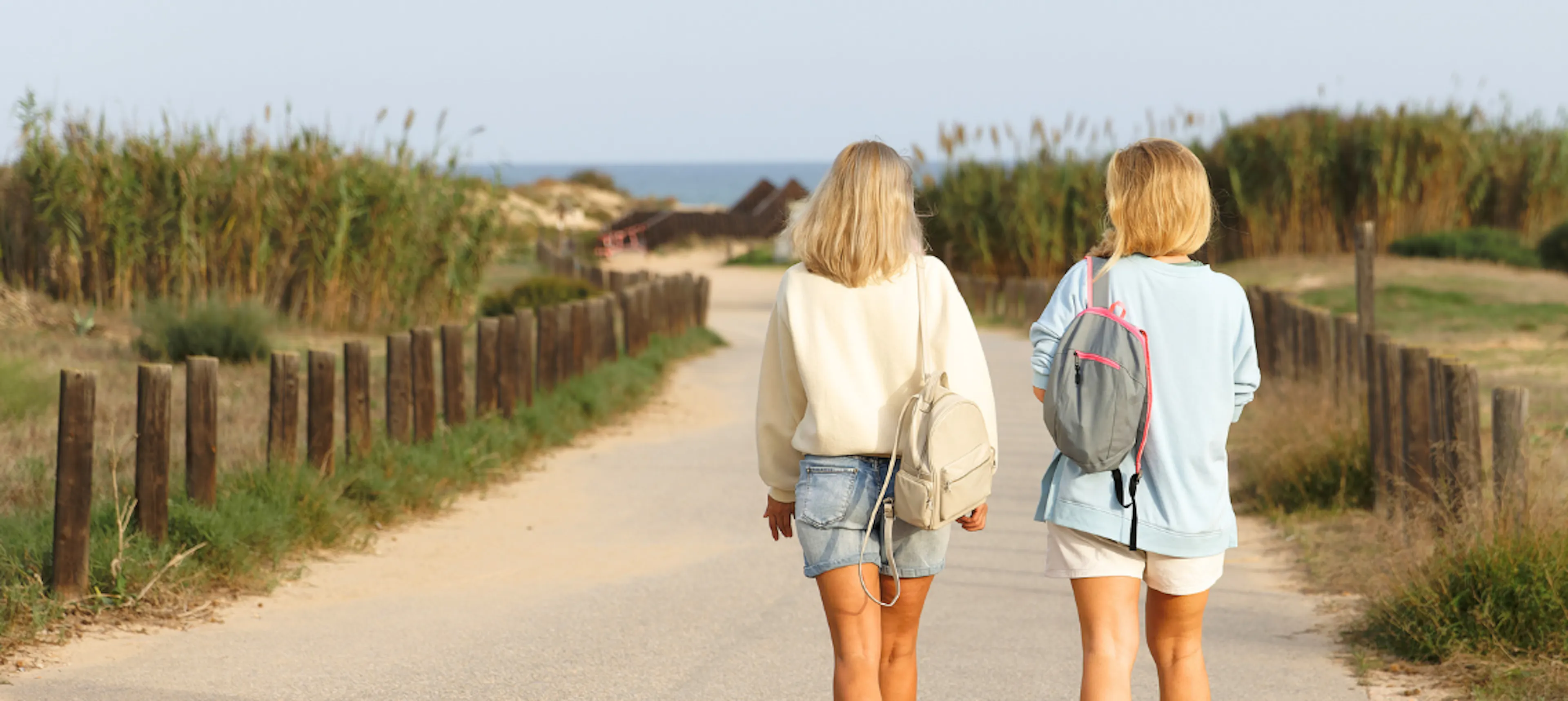 Two women walking and talking representing one friend checking in on the other