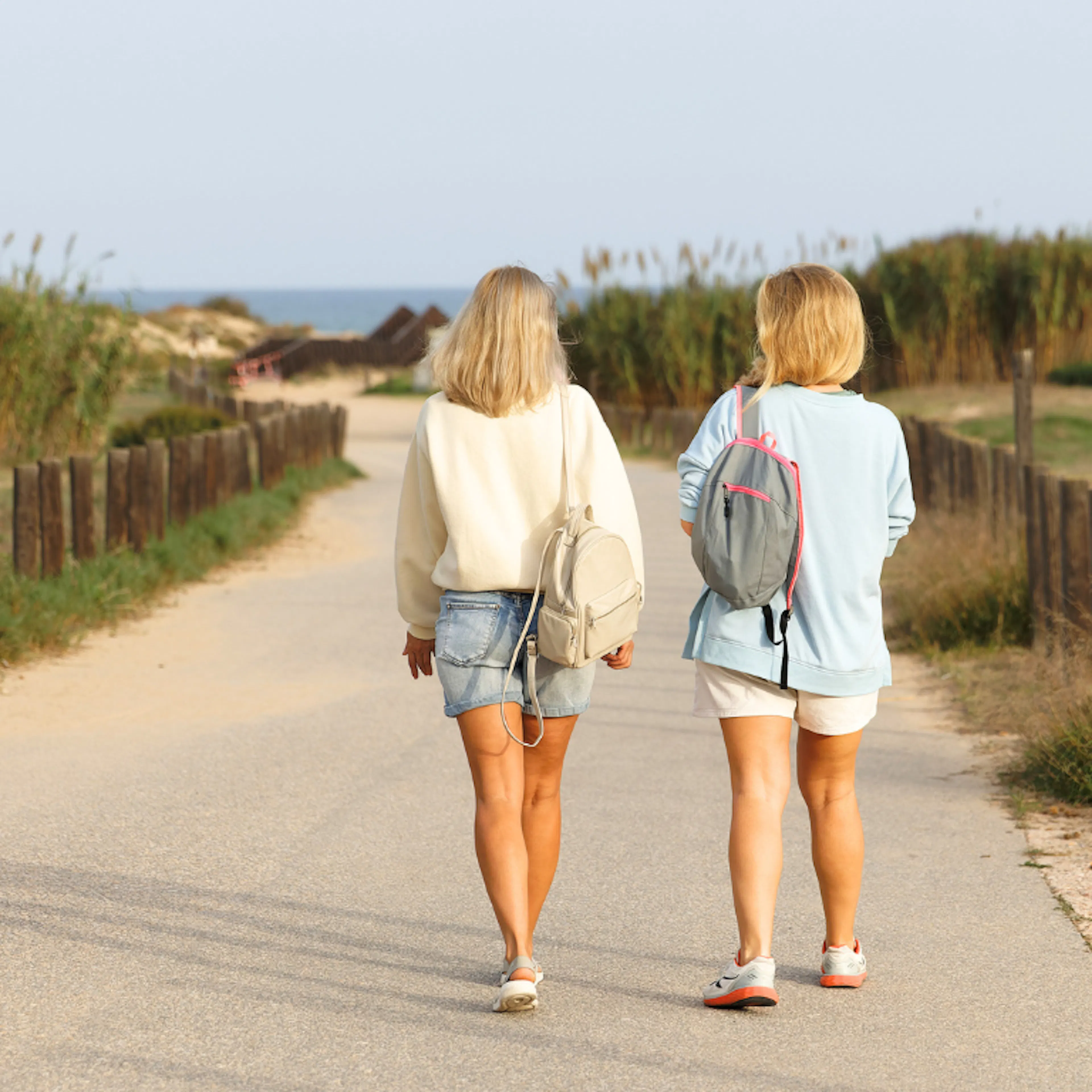 Two women walking and talking representing one friend checking in on the other
