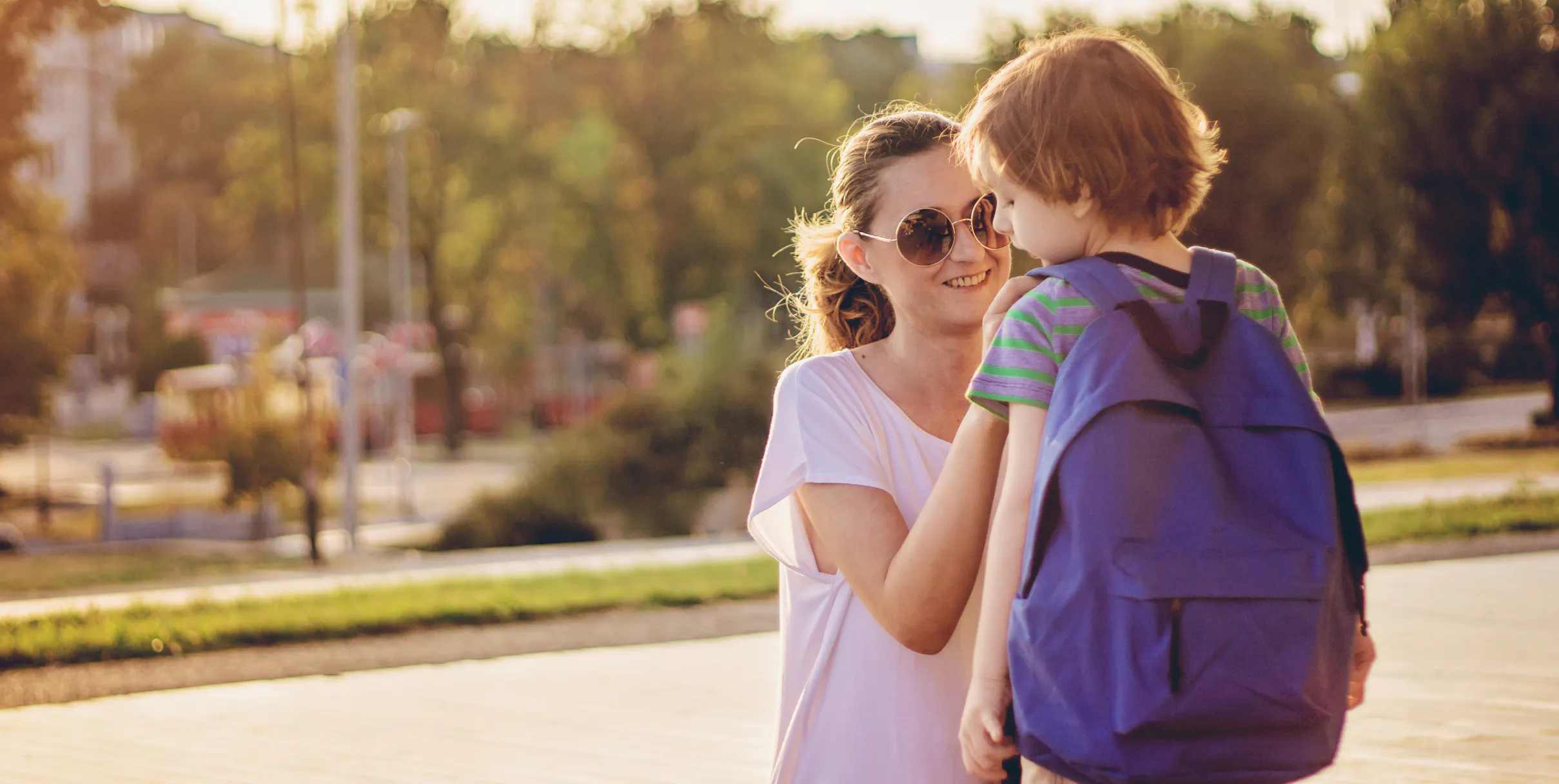 Mother smiling while she sends her son back to school
