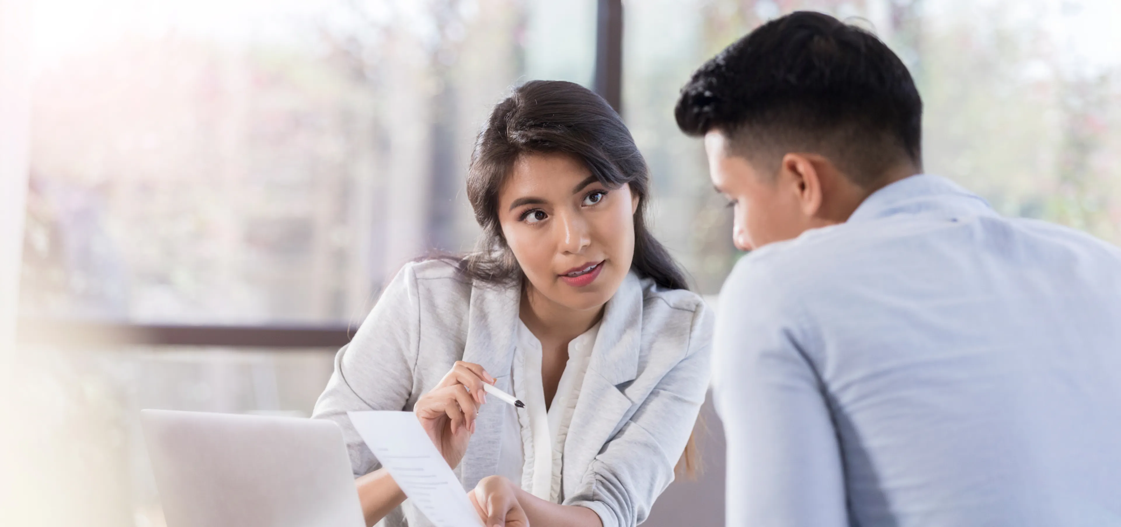 Manager walking an employee through a document during a formal annual performance review