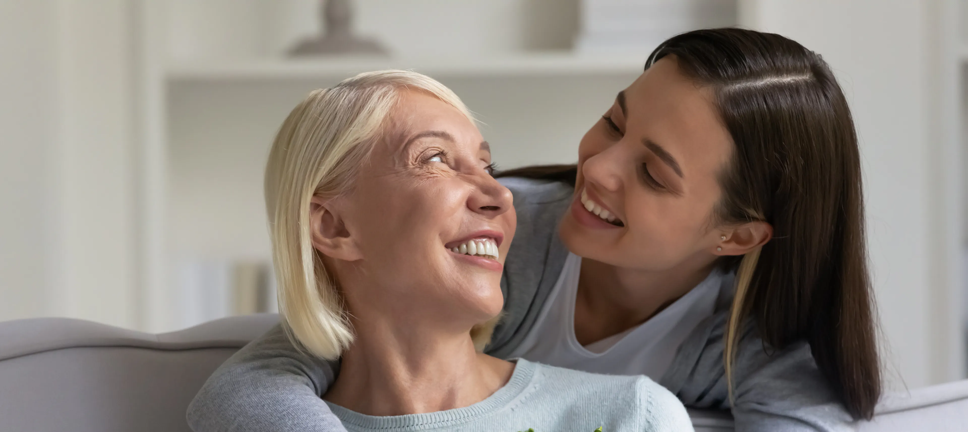 Mother and daughter embracing and laughing together
