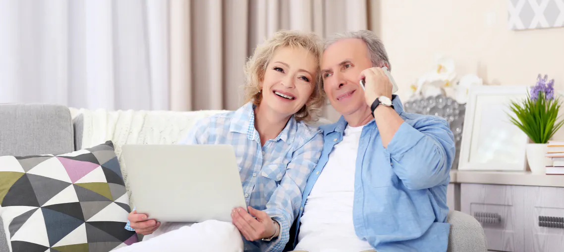 Grandparents smiling while on a call with family