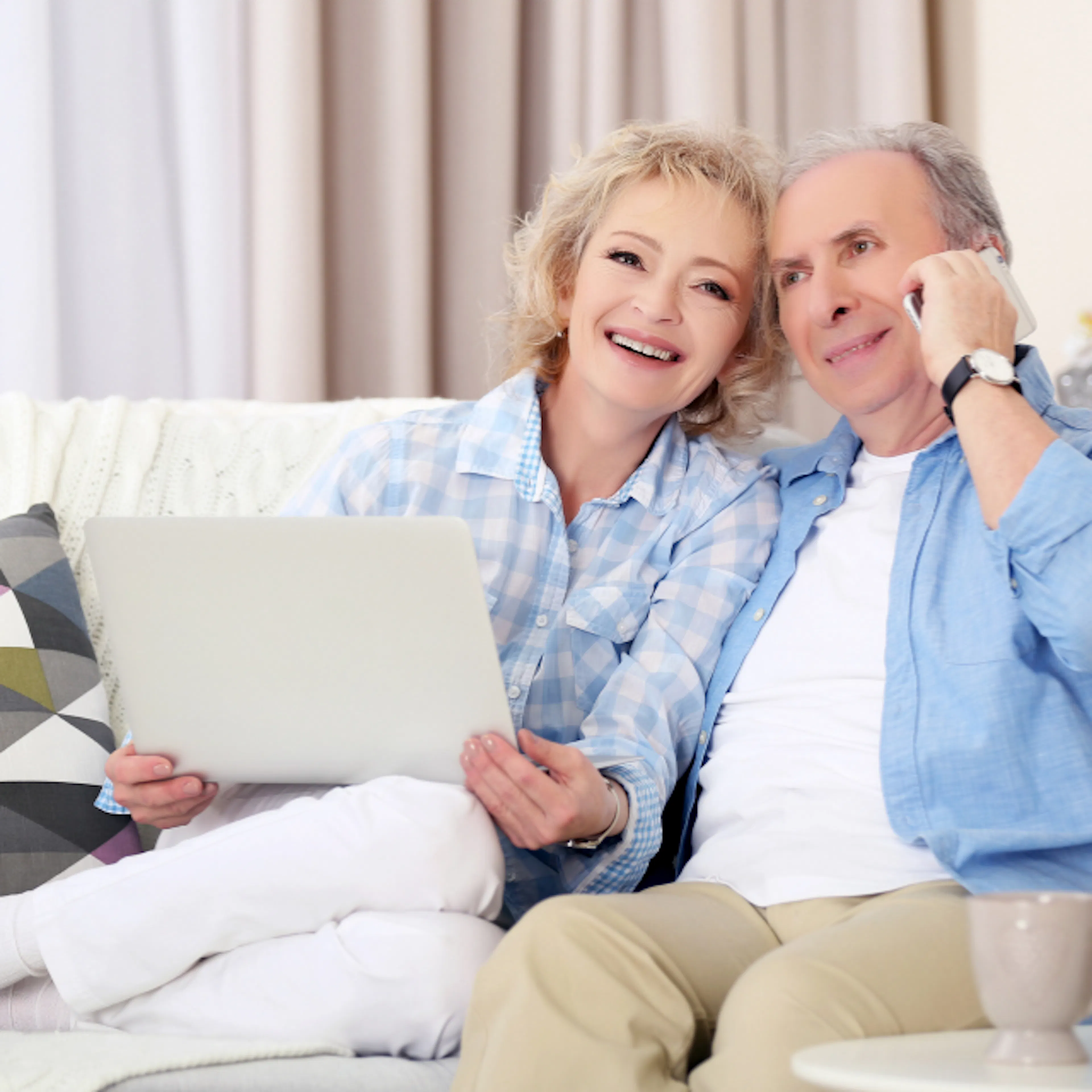 Grandparents smiling while on a call with family