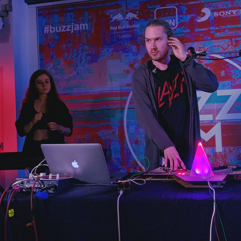 Lake Komo, a two-piece band, playing on stage with Stardis, a custom built vocal sampler and looper, with in-built stage lighting controls