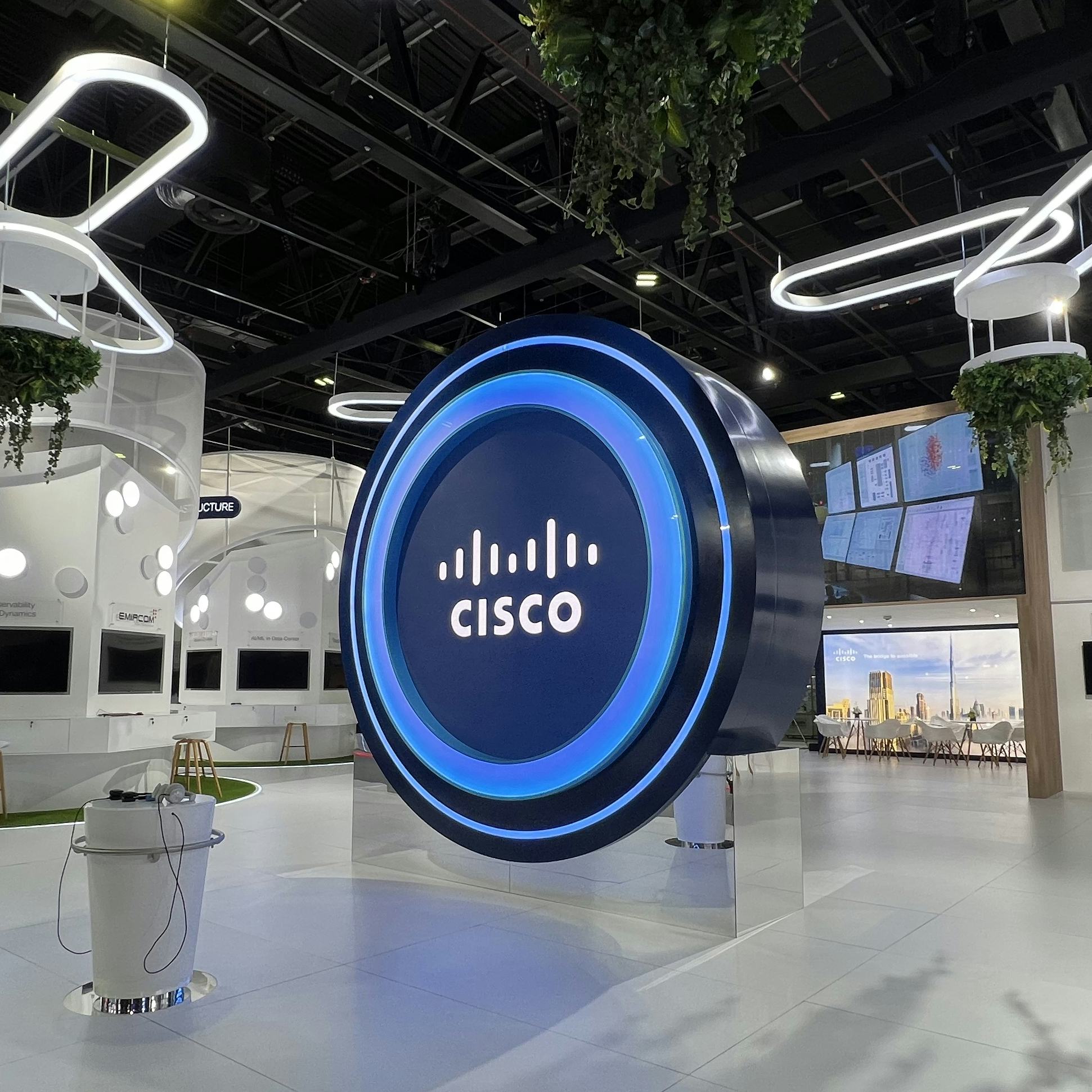 A giant blue portal-like screen sits within a minimalist white stand at GITEX, a technology expo in Dubai.