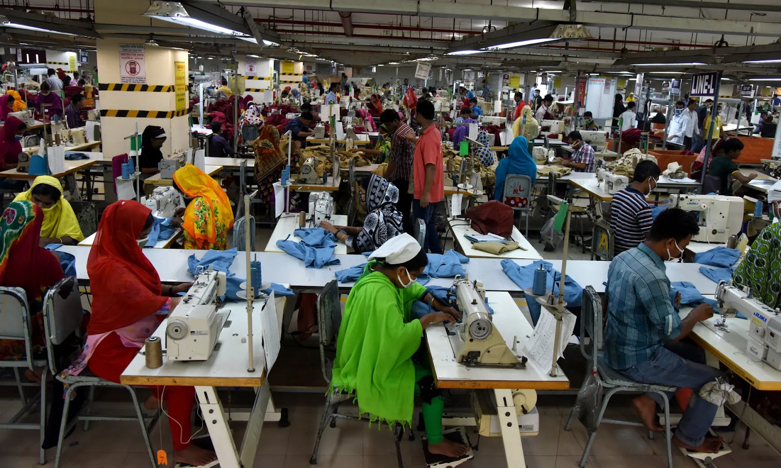 Garment workers tightly packed into a factory in Dhaka, Bangladesh. Photograph by NurPhoto via Getty Images