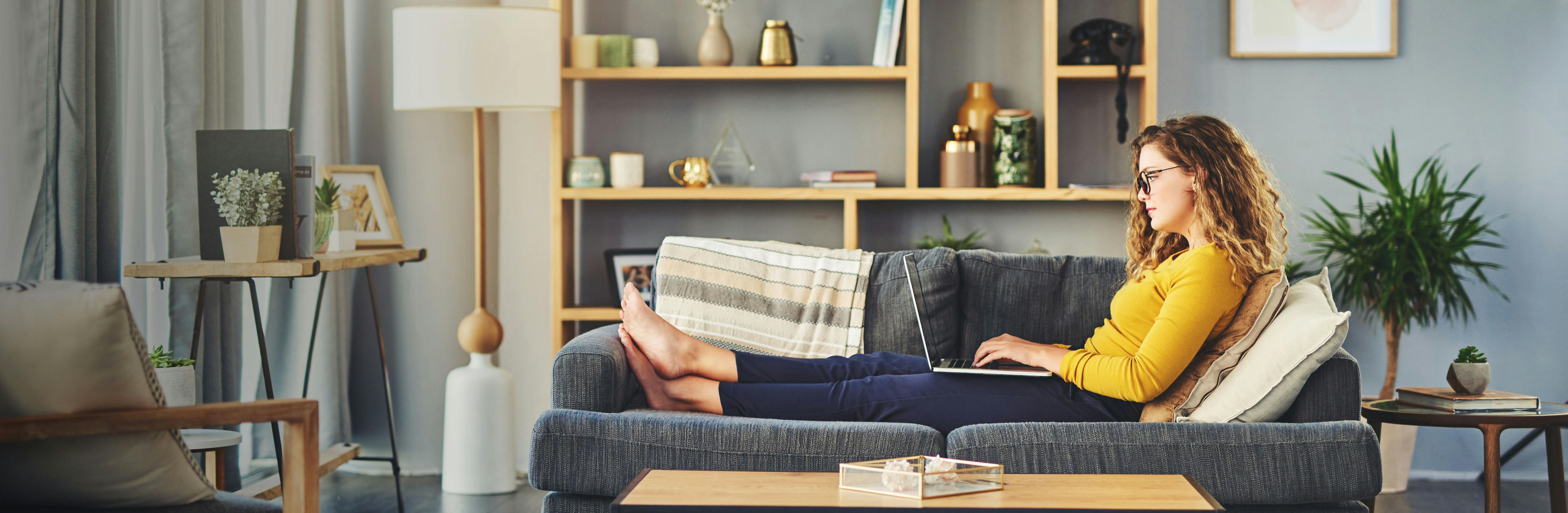 Young woman on couch with a laptop