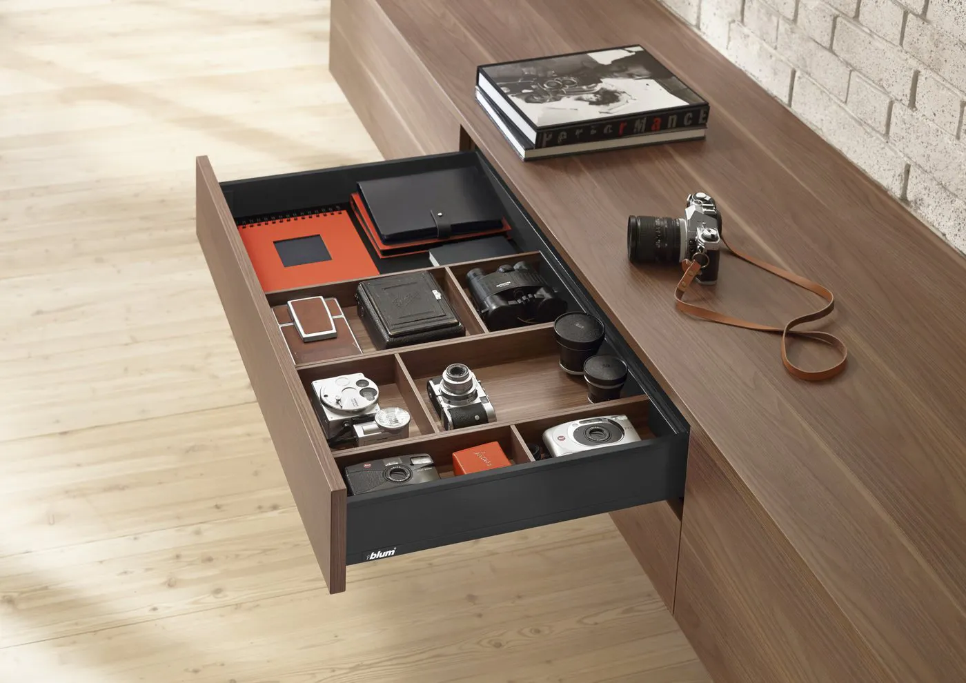 Blum LEGRABOX drawer in a dark finish, open in a walnut cabinet