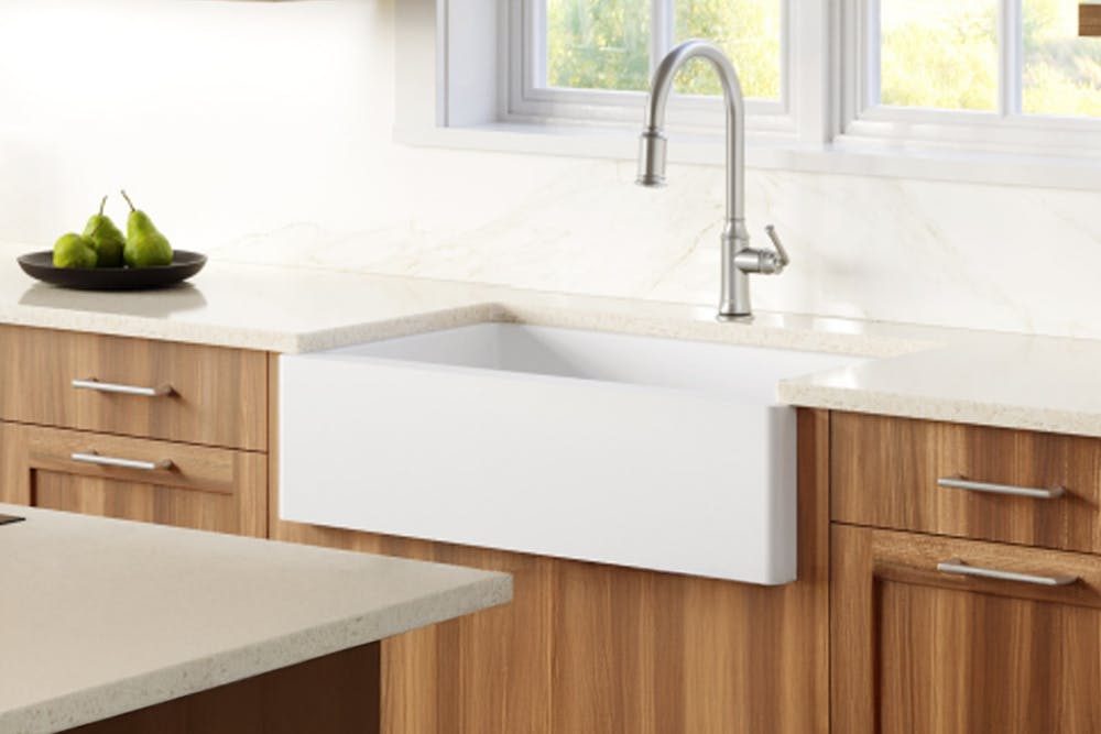 Bright kitchen with a Karran quartz farmhouse sink in white aproned front, styled with farmhouse décor.