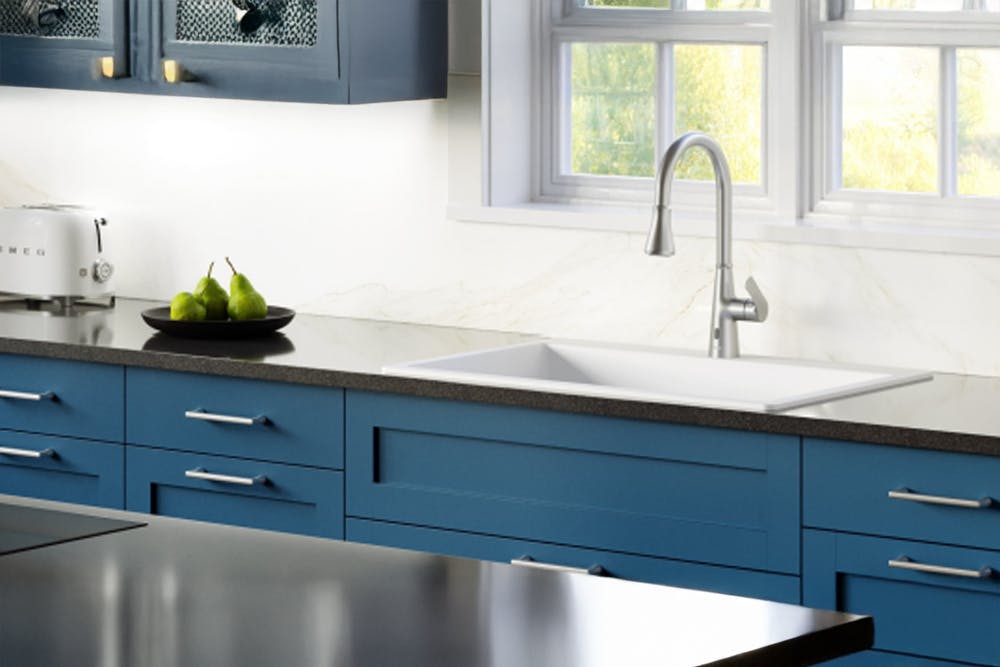 Elegant kitchen vignette with a clean white quartz Karran sink and modern faucet setup.