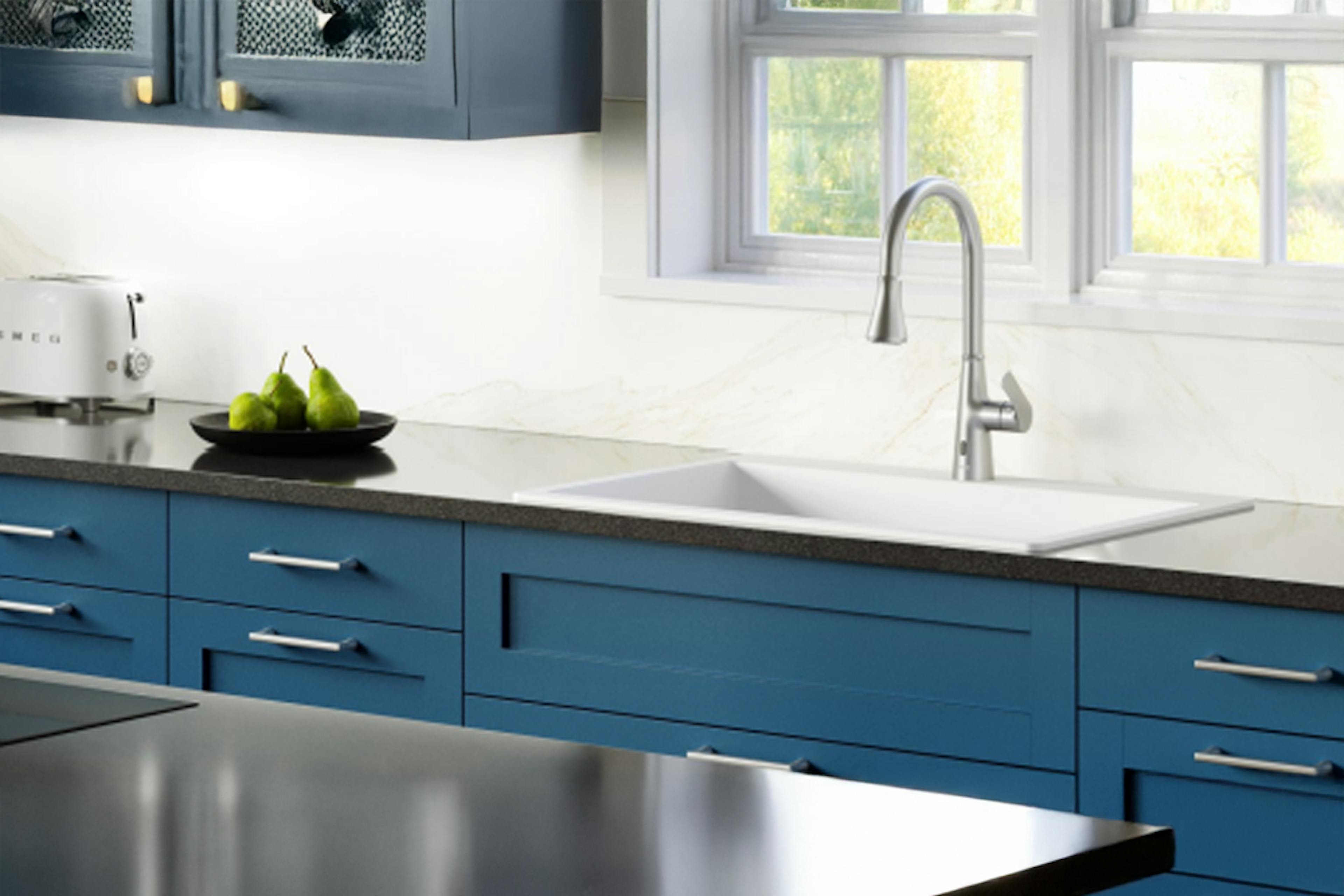 Elegant kitchen vignette with a clean white quartz Karran sink and modern faucet setup.