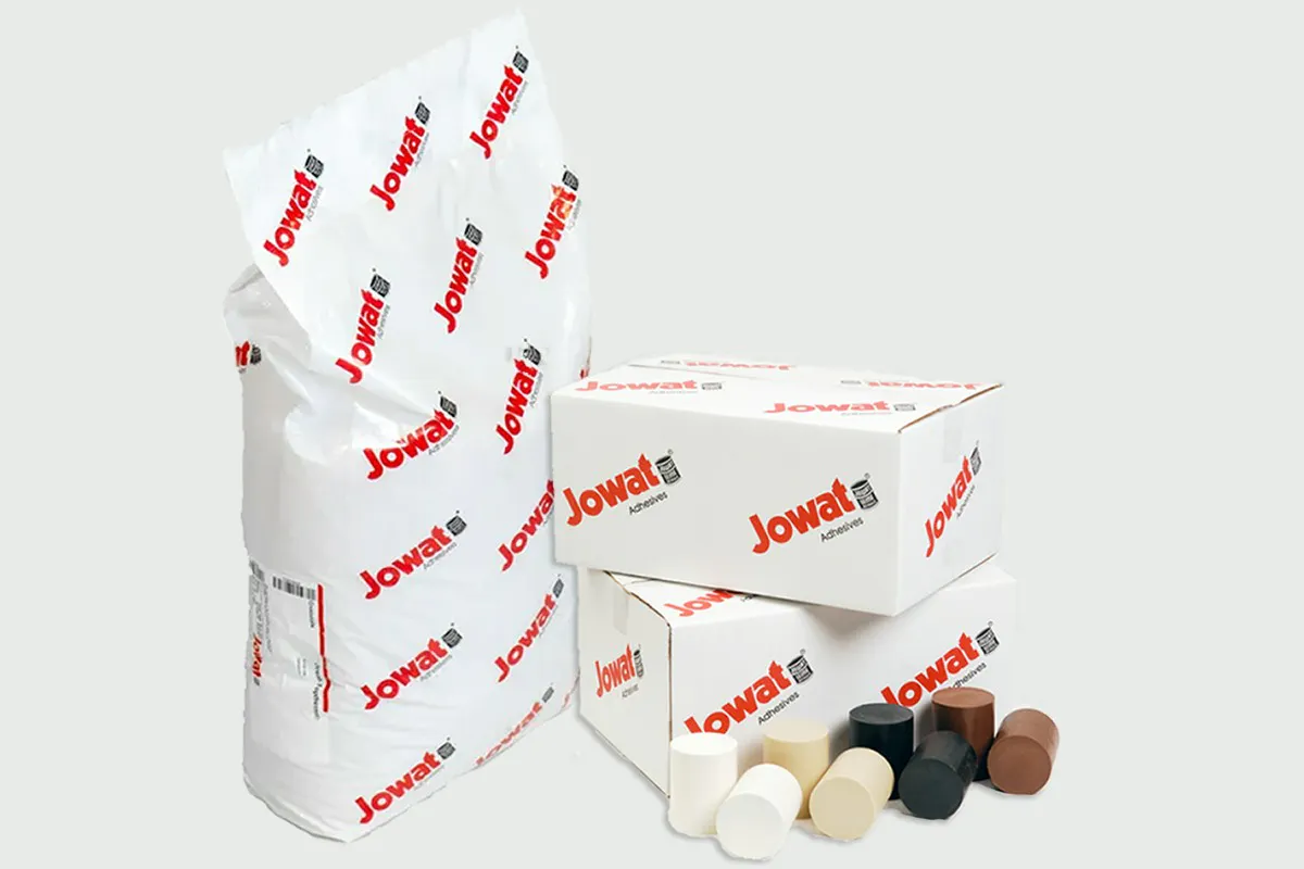 Jowat hot melt adhesive in a 44 lb bag and boxes, with hot melt cartridges in several colours