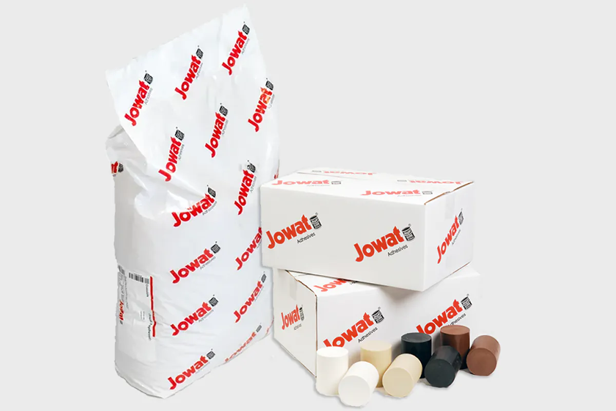 Jowat hot melt adhesive in a 44 lb bag and boxes, with hot melt cartridges in several colours