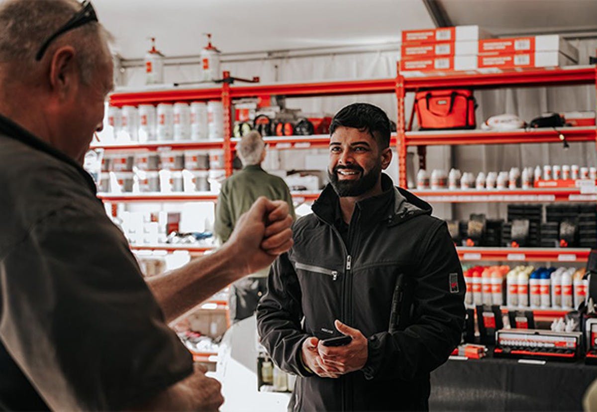 Two people talking in front of ORSY rack