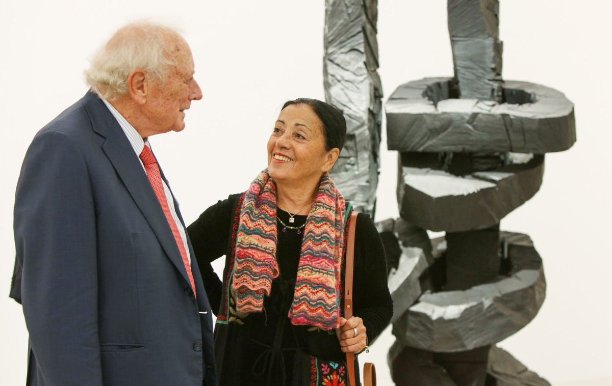 Reinhold and Carmen Würth at the opening of the art exhibition "Lust auf mehr" in front of Georg Baselitz' sculpture "Yellow Song" from the Würth Collection.