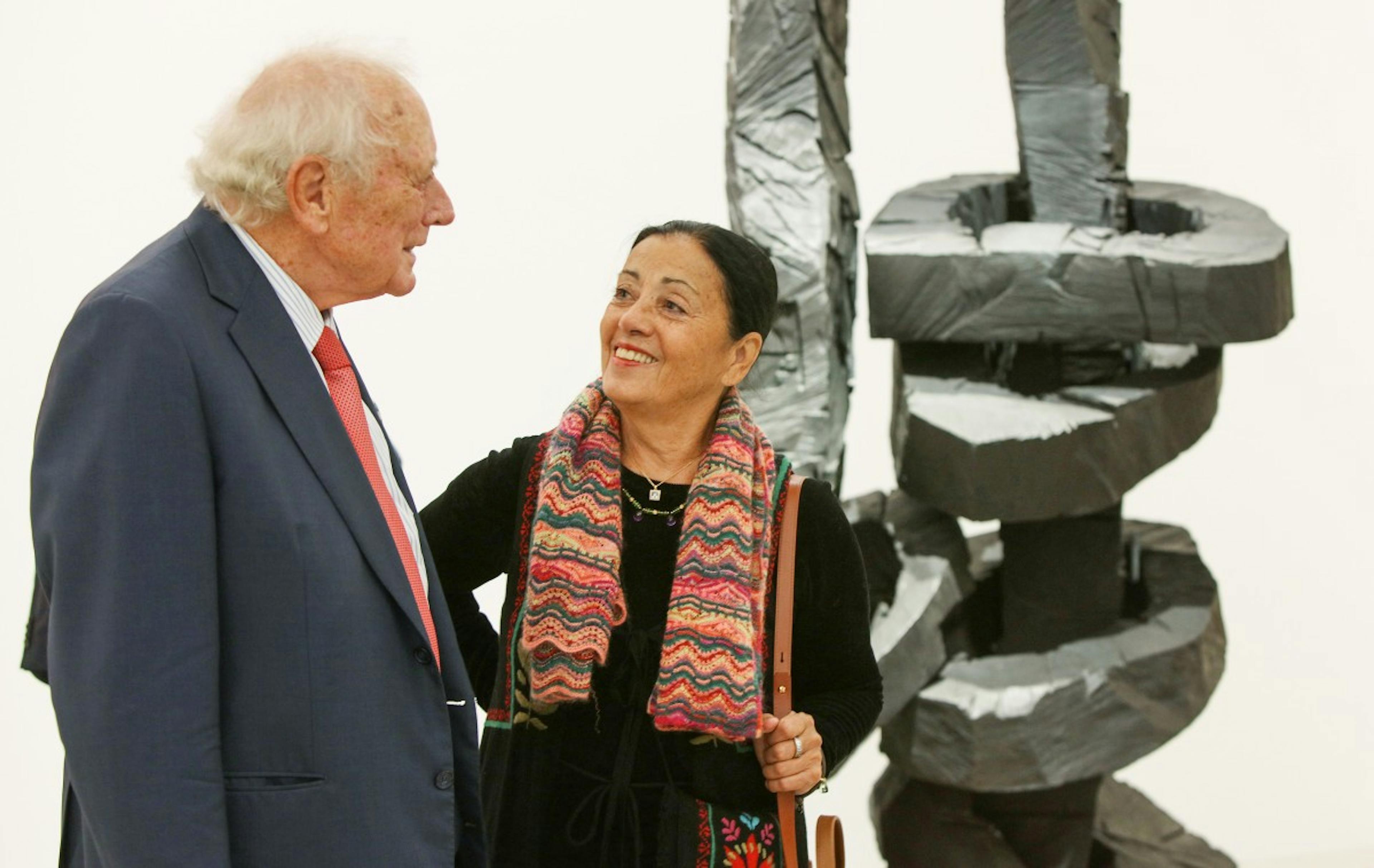 Reinhold and Carmen Würth at the opening of the art exhibition "Lust auf mehr" in front of Georg Baselitz' sculpture "Yellow Song" from the Würth Collection.