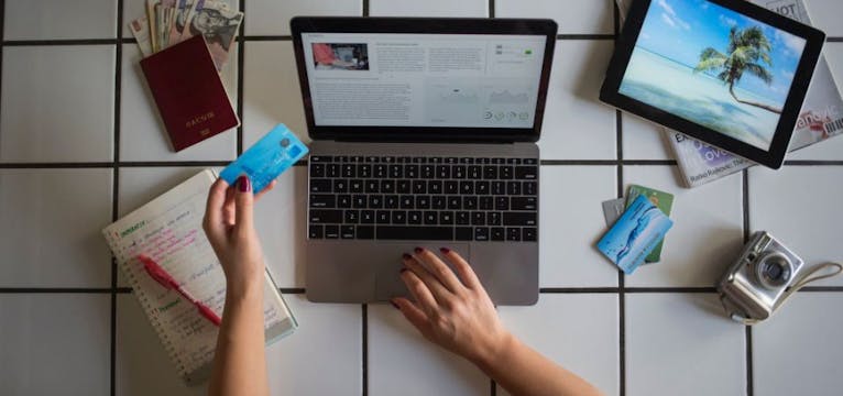 Woman using her computer to search for holidays.